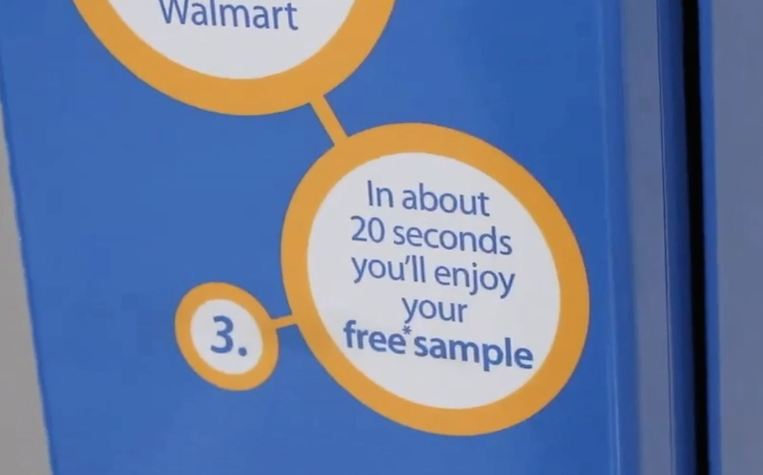 Close-up of a blue product packaging with orange and white circles containing text about sampling, including Walmart branding and numbered steps.