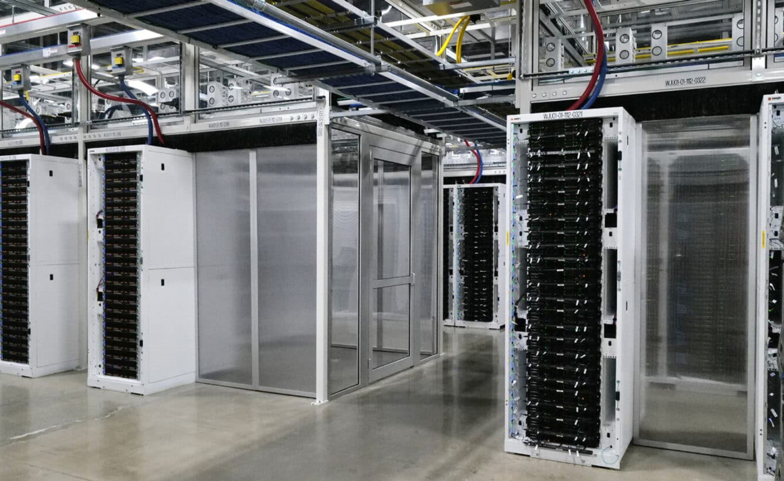 Data center server racks with server hardware and cabling in a clean, well-organized environment.