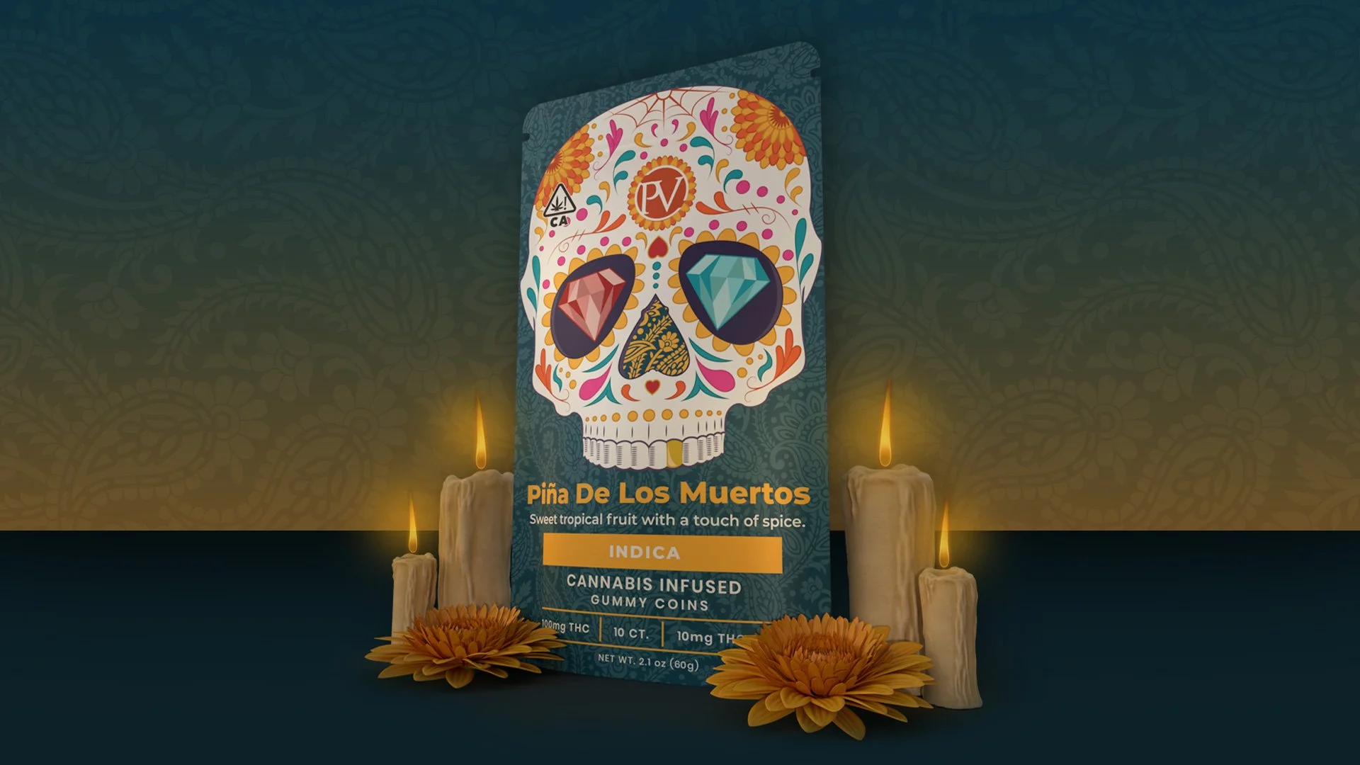 Box of Piña De Los Muertos cannabis-infused gummy candies decorated with a colorful sugar skull face, flanked by lit candles and marigold flowers, with a patterned wallpaper background.