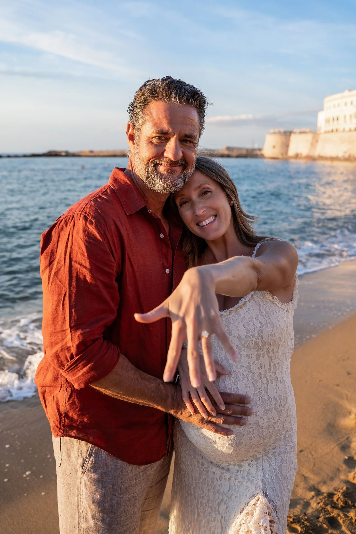 Happy newly engaged couple showing off the engagement ring after a surprise proposal in Puglia.