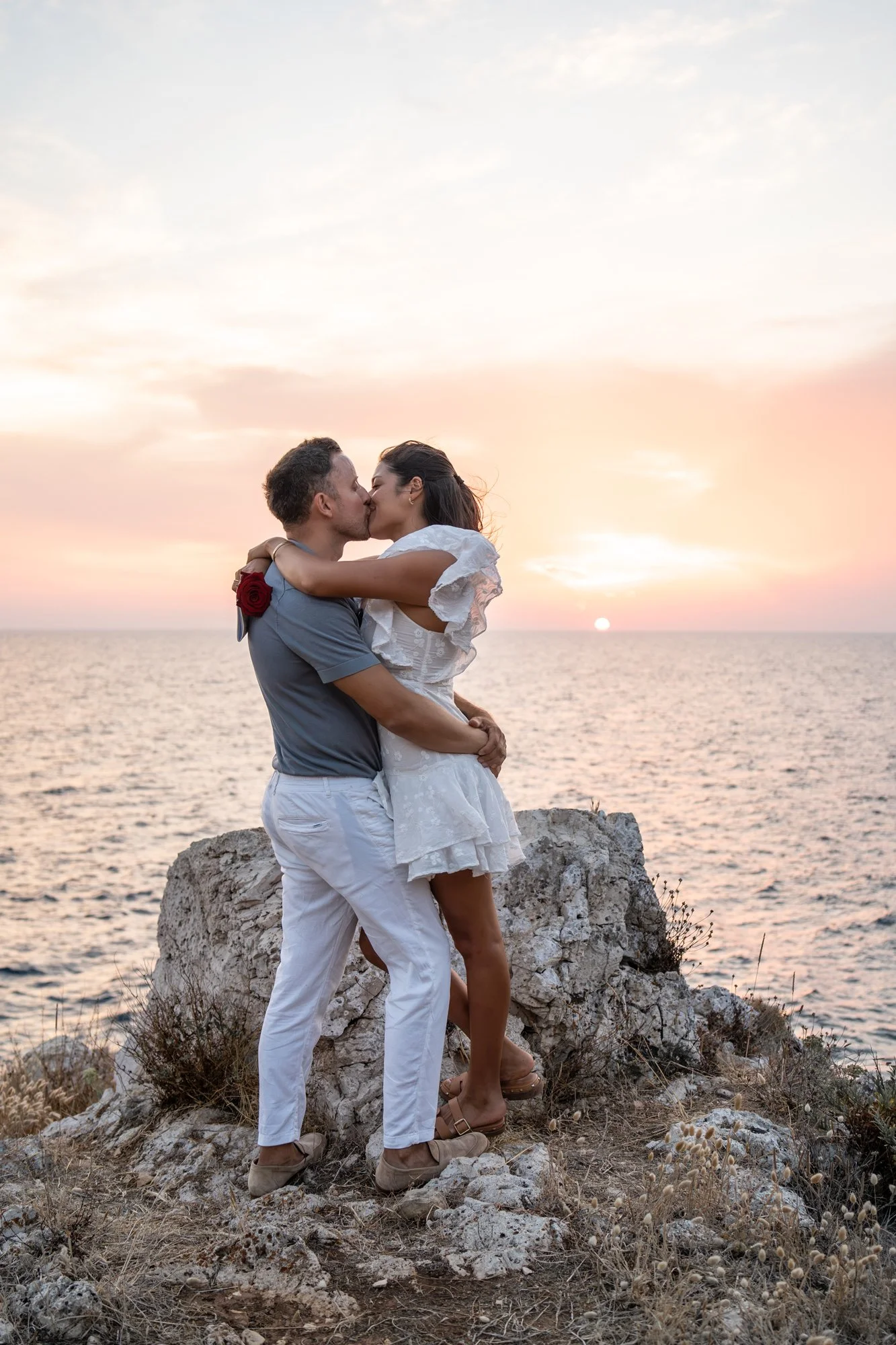 Golden hour sunset kiss by the Mediterranean Sea during an intimate vow renewal photoshoot in Apulia.
