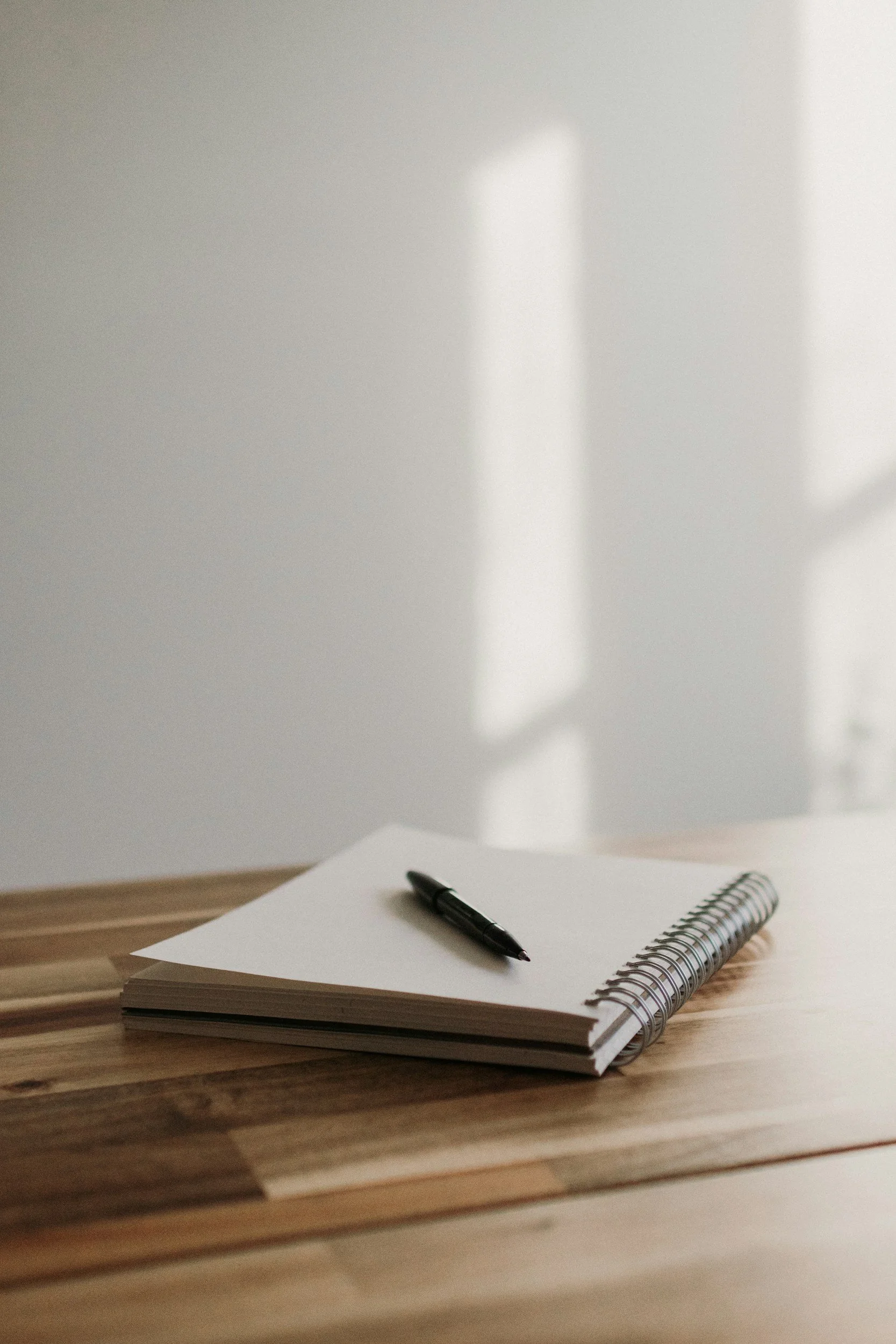 A pen on a notebook on a table