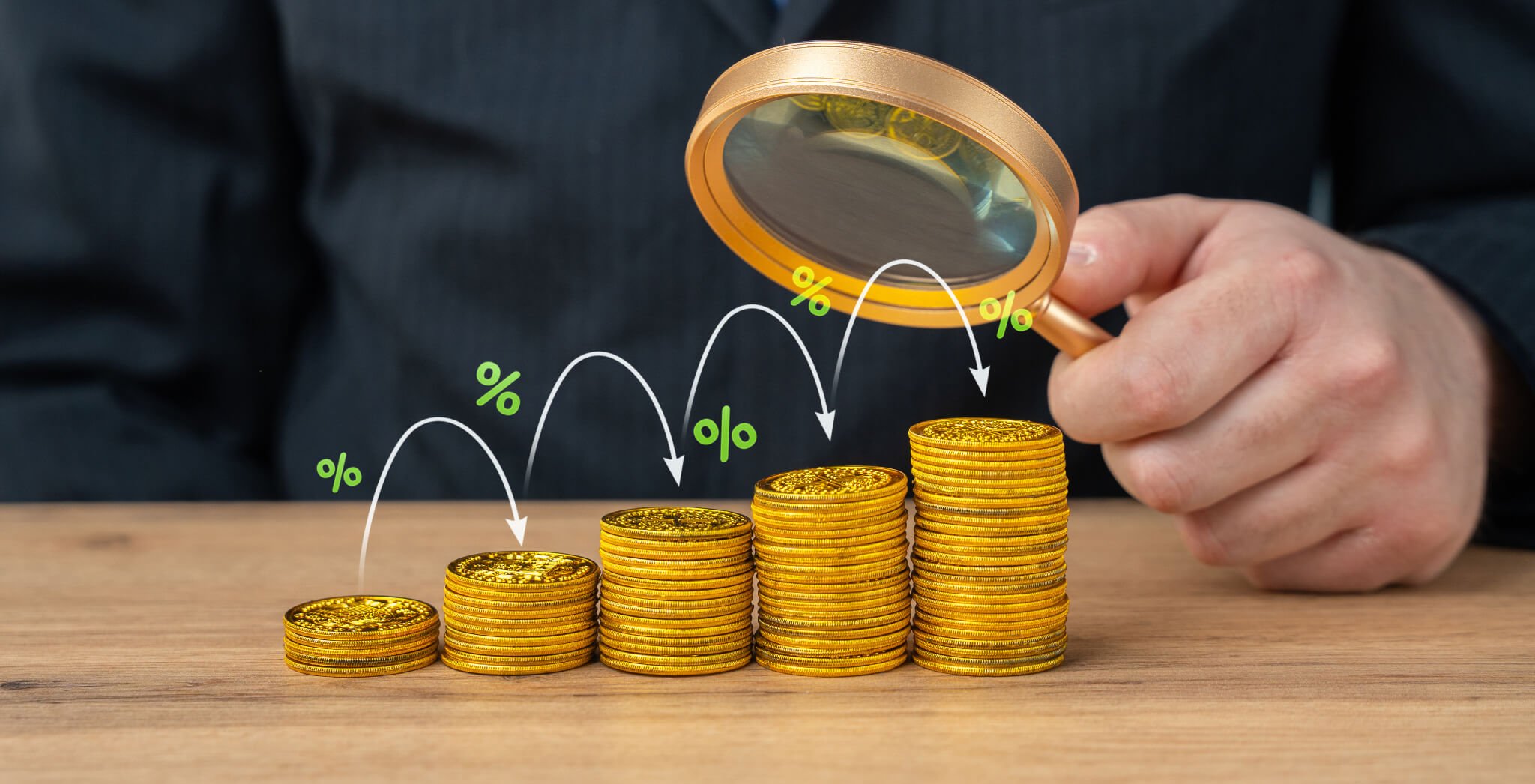 Person holding a magnifying glass over stacks of gold coins, with white and green percentage symbols and arrows indicating growth or decline.