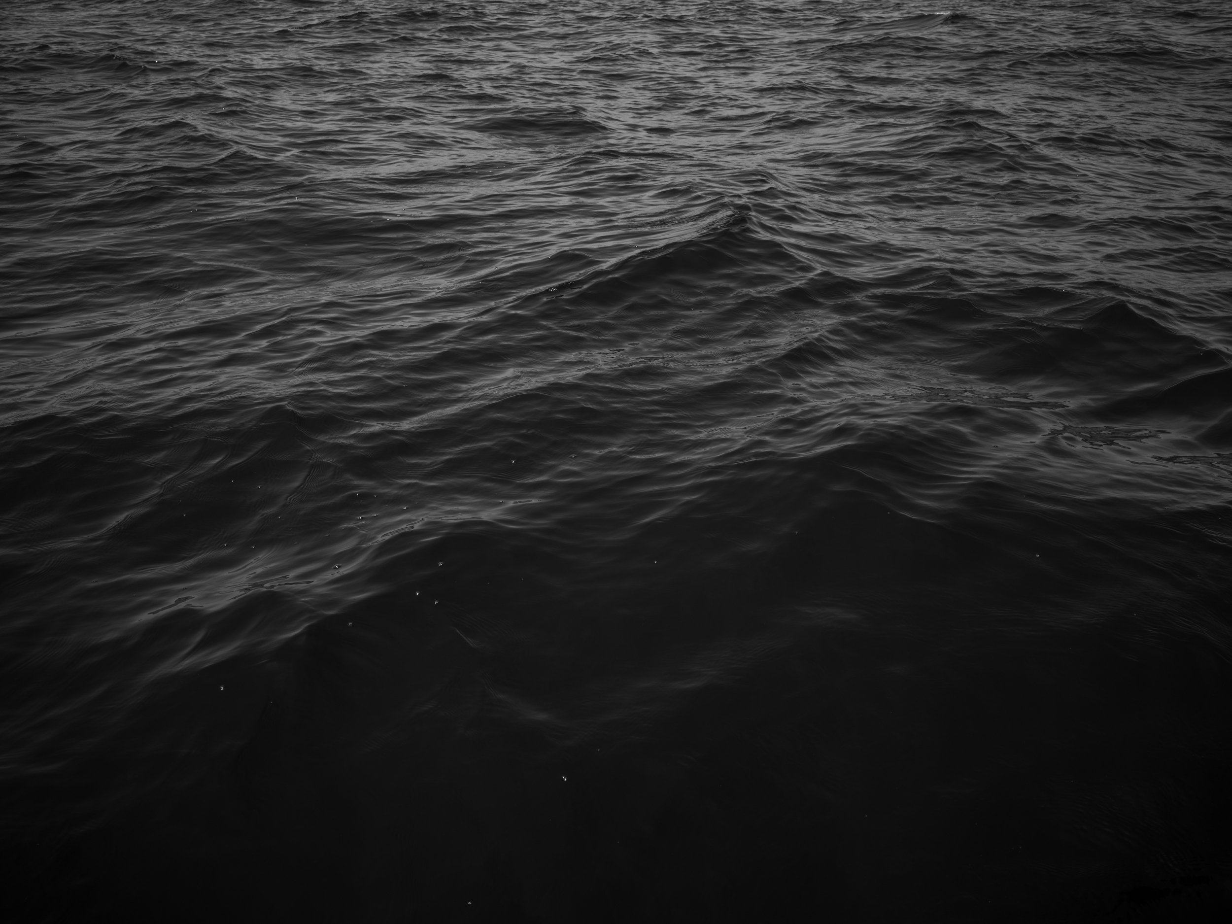 Dark ocean water with ripples and waves.