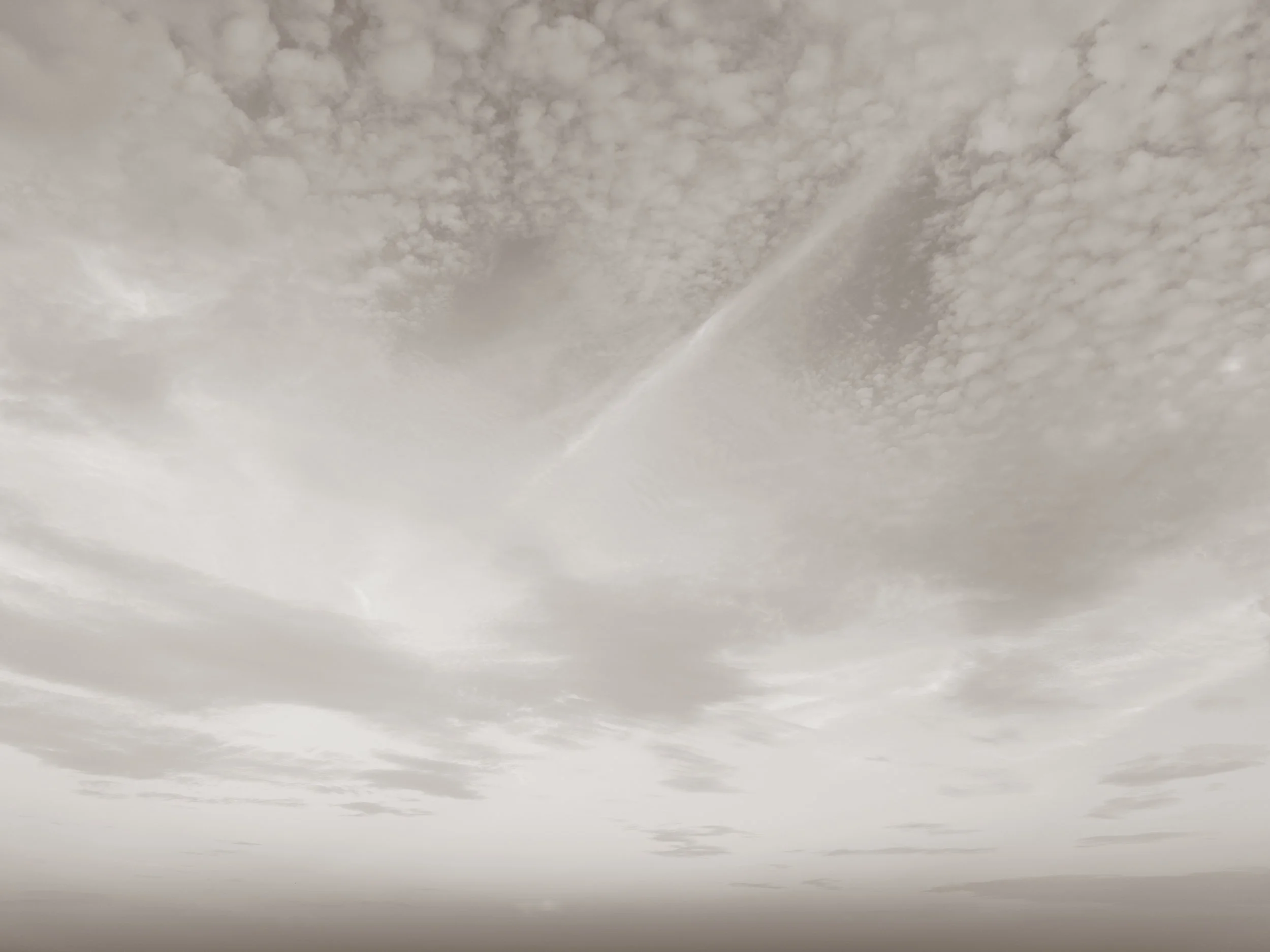 A cloudy sky with scattered clouds.