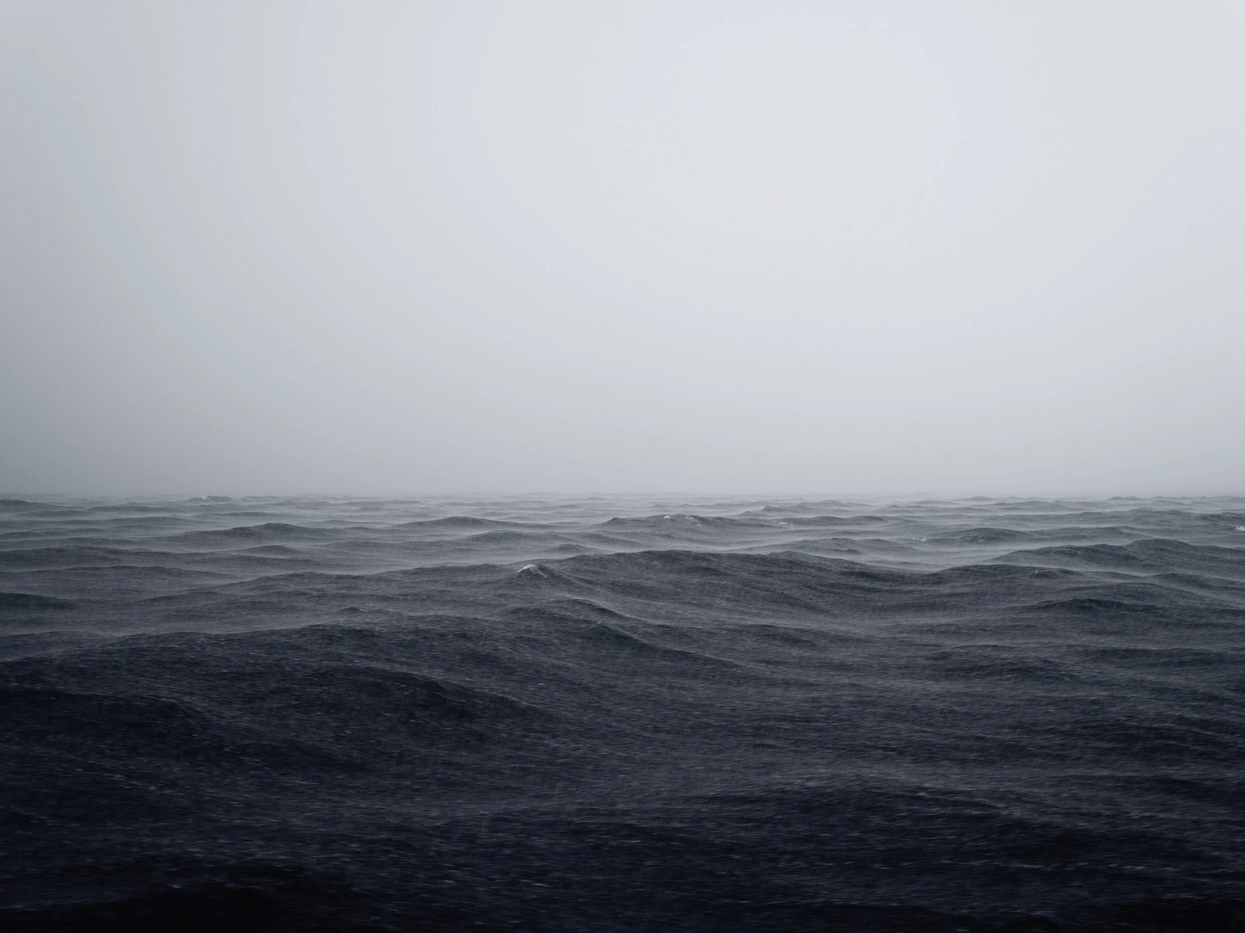 Overcast sky with dark ocean waves