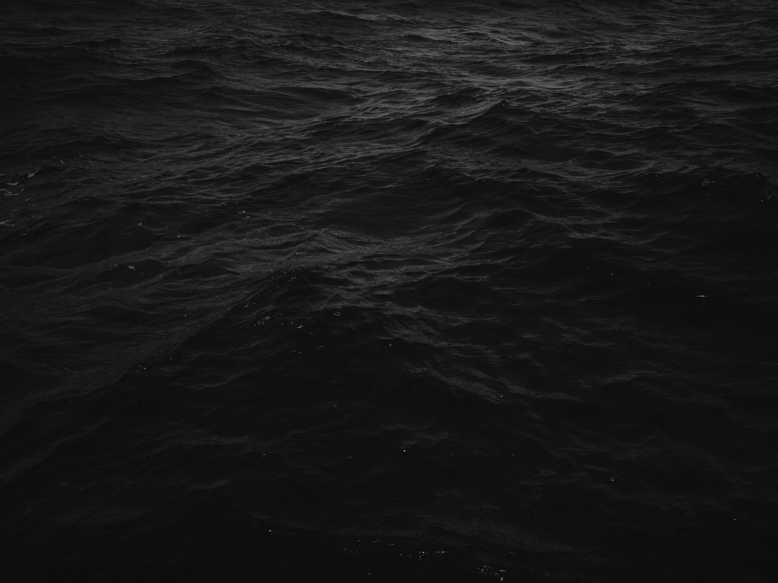 Dark ocean water with choppy waves.
