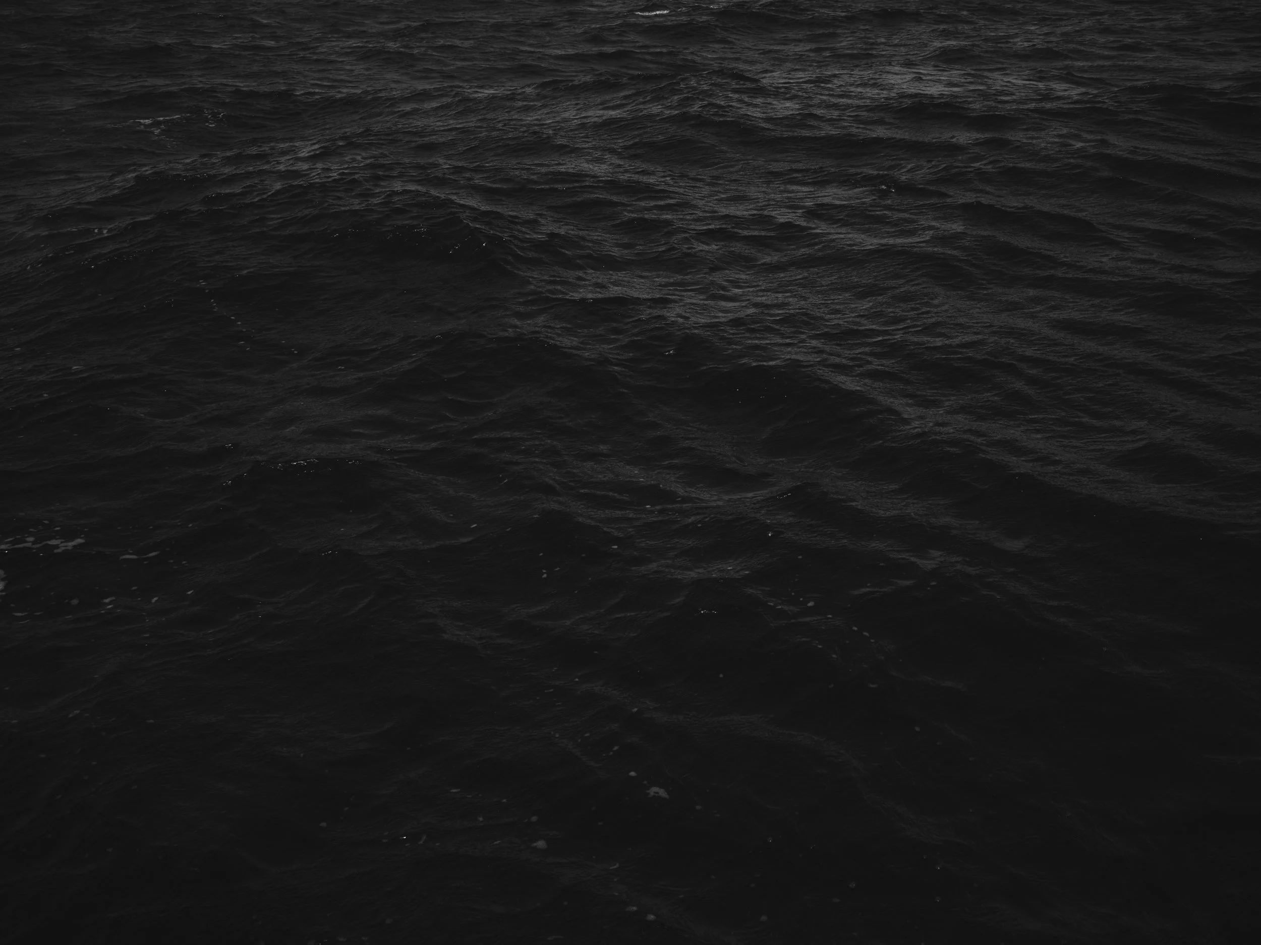 Dark ocean surface with small waves and ripples