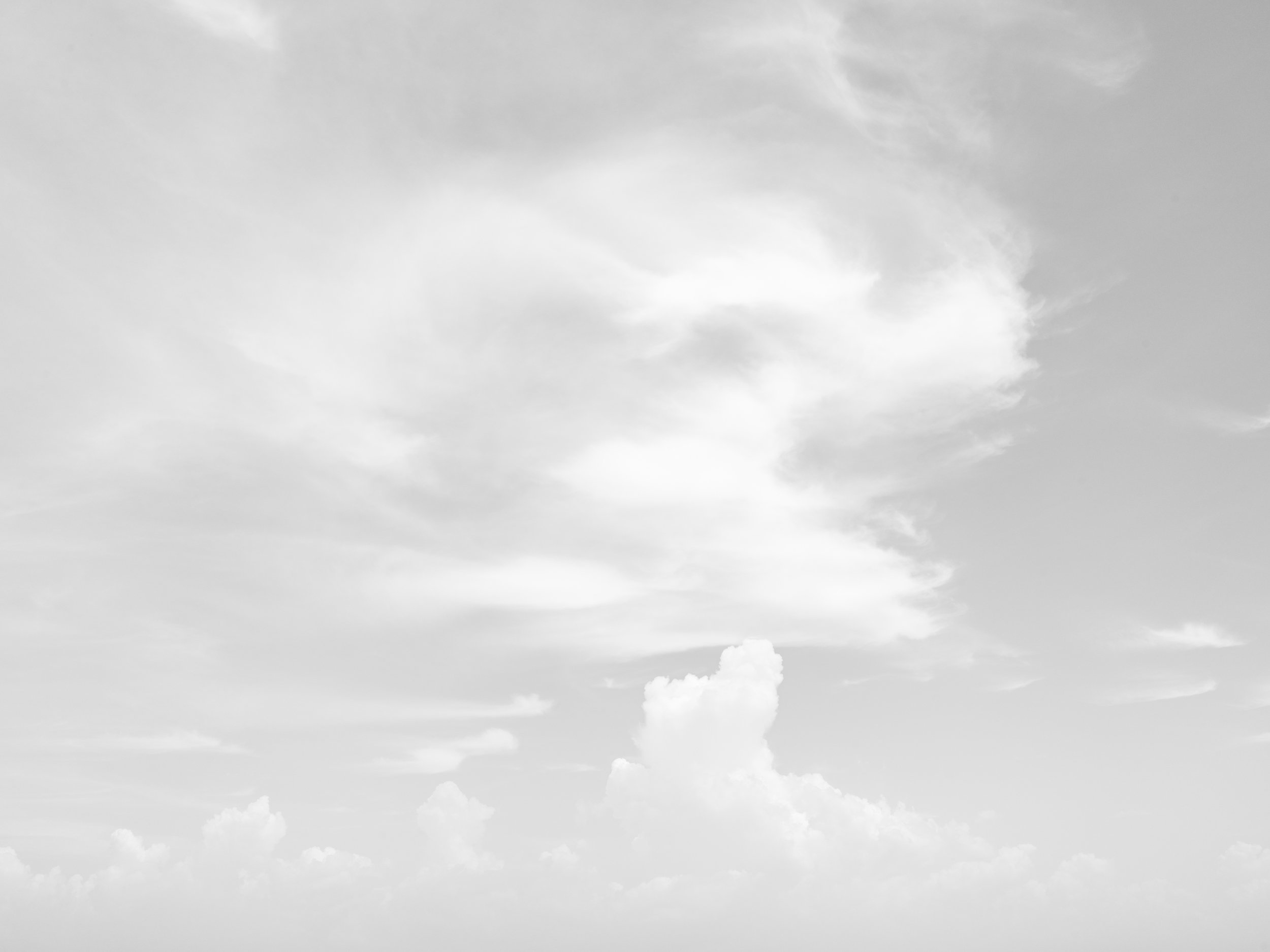 Gray overcast sky with scattered clouds.