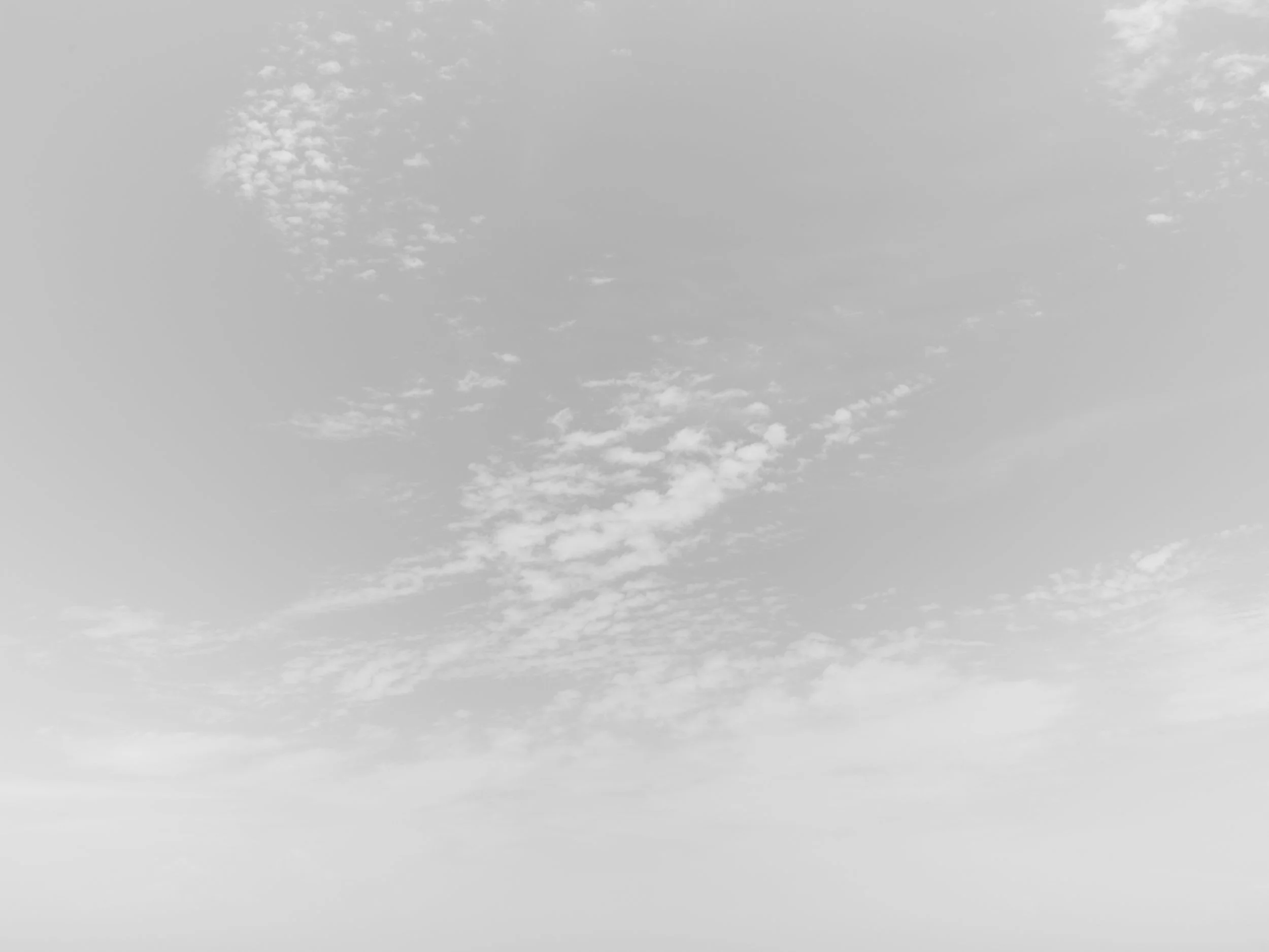 Gray sky with scattered clouds.