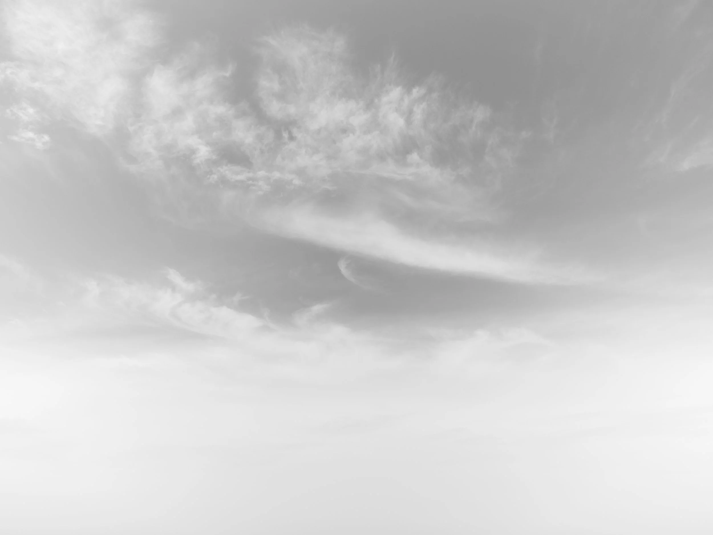 Gray sky with scattered clouds.