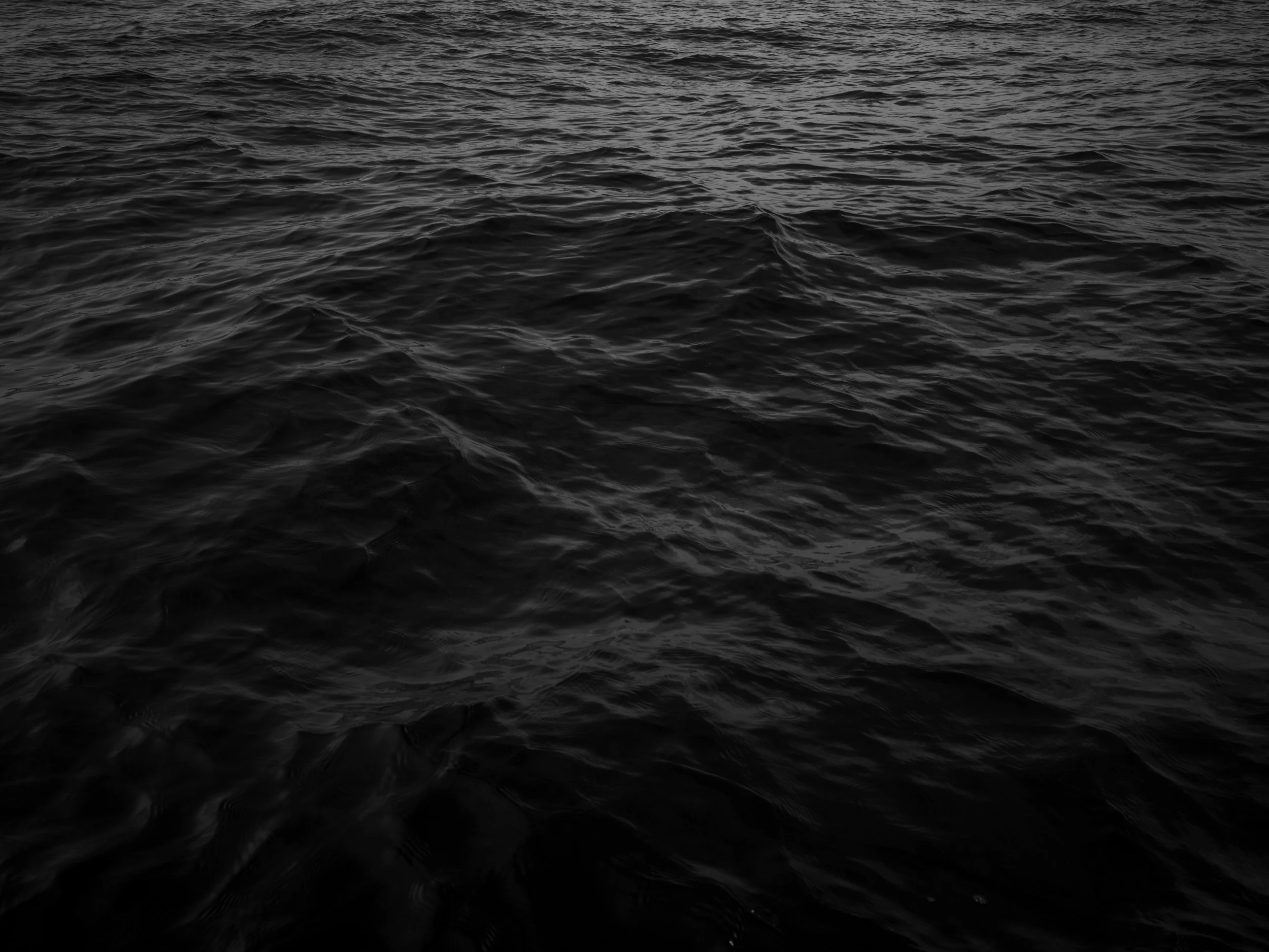 Dark, rippling ocean surface with no objects visible.