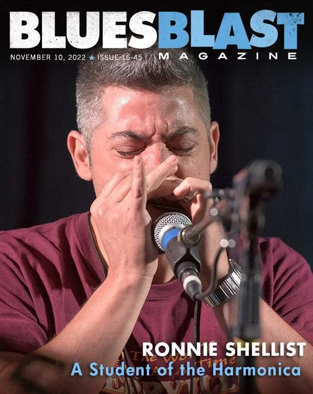 Magazine cover story about Ronnie Shellist, described as a student playing a harmonica in front of a microphone. The magazine is titled Blue Blast, issue date November 10, 2022.