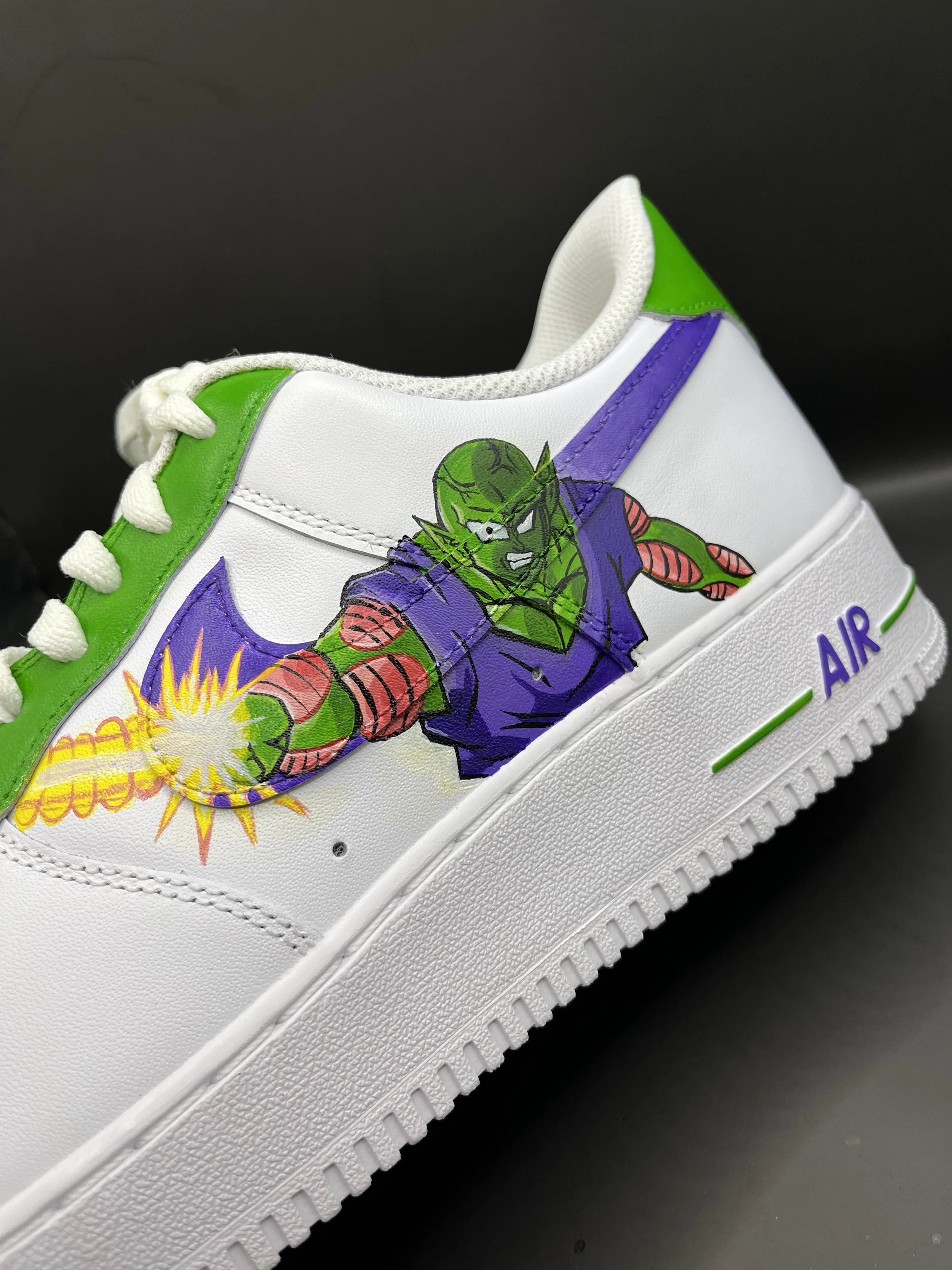 White sneaker with green, purple, and red design featuring a comic-style character and explosive graphics.