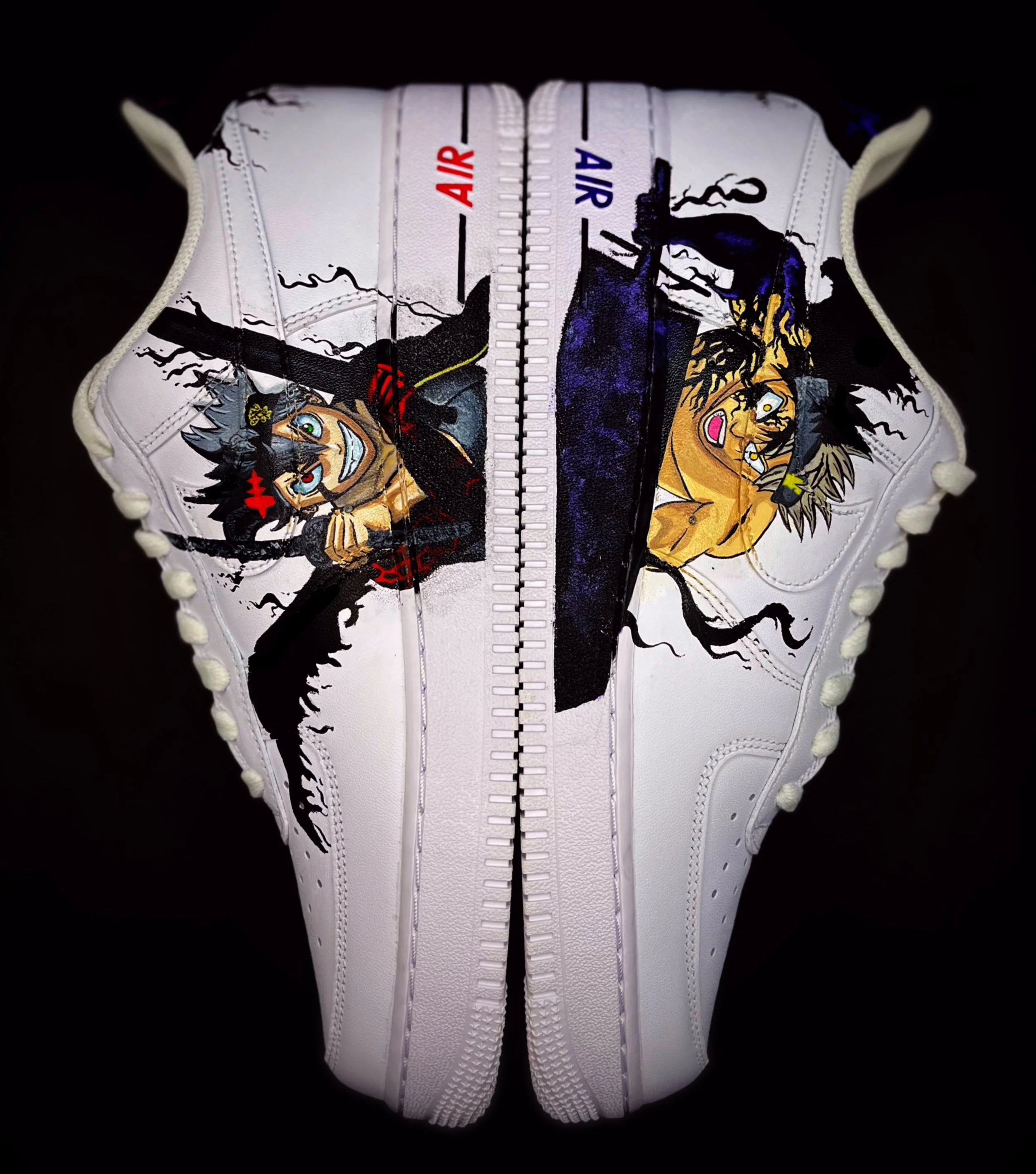 Close-up of a white sneaker with illustrated characters, black, yellow, and red accents, and the word 'AIR' printed in red and blue near the top of the shoe.