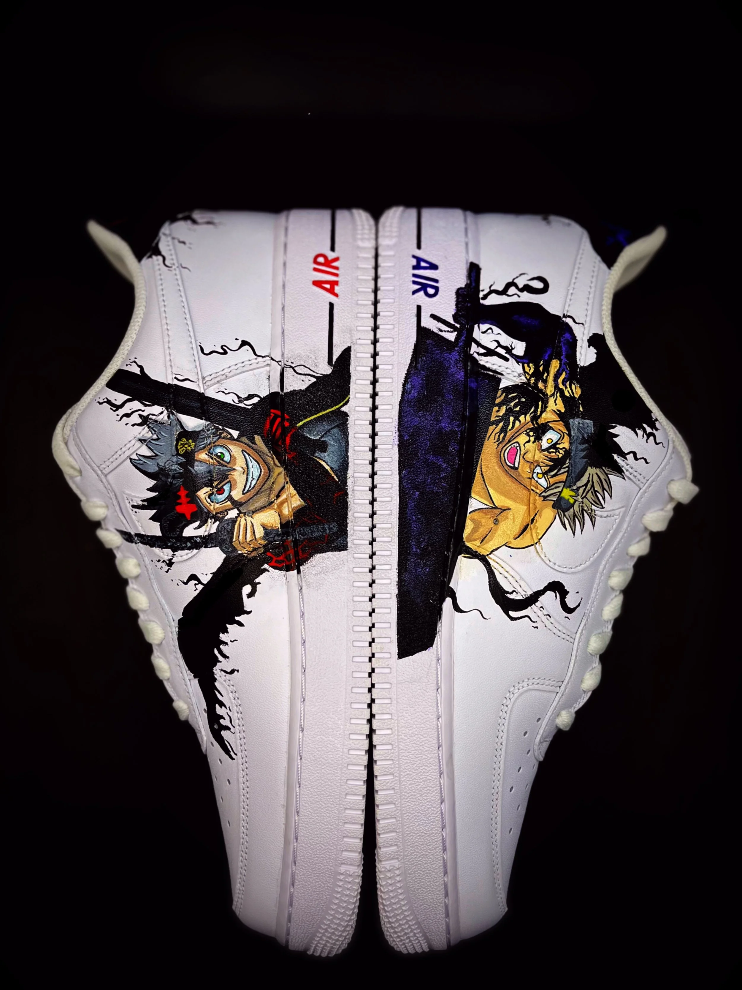 Close-up of a white sneaker with a colorful graphic design of cartoon characters on the tongue, featuring a zipper running down the middle, with the word 'AIR' in red and blue on the zipper track.