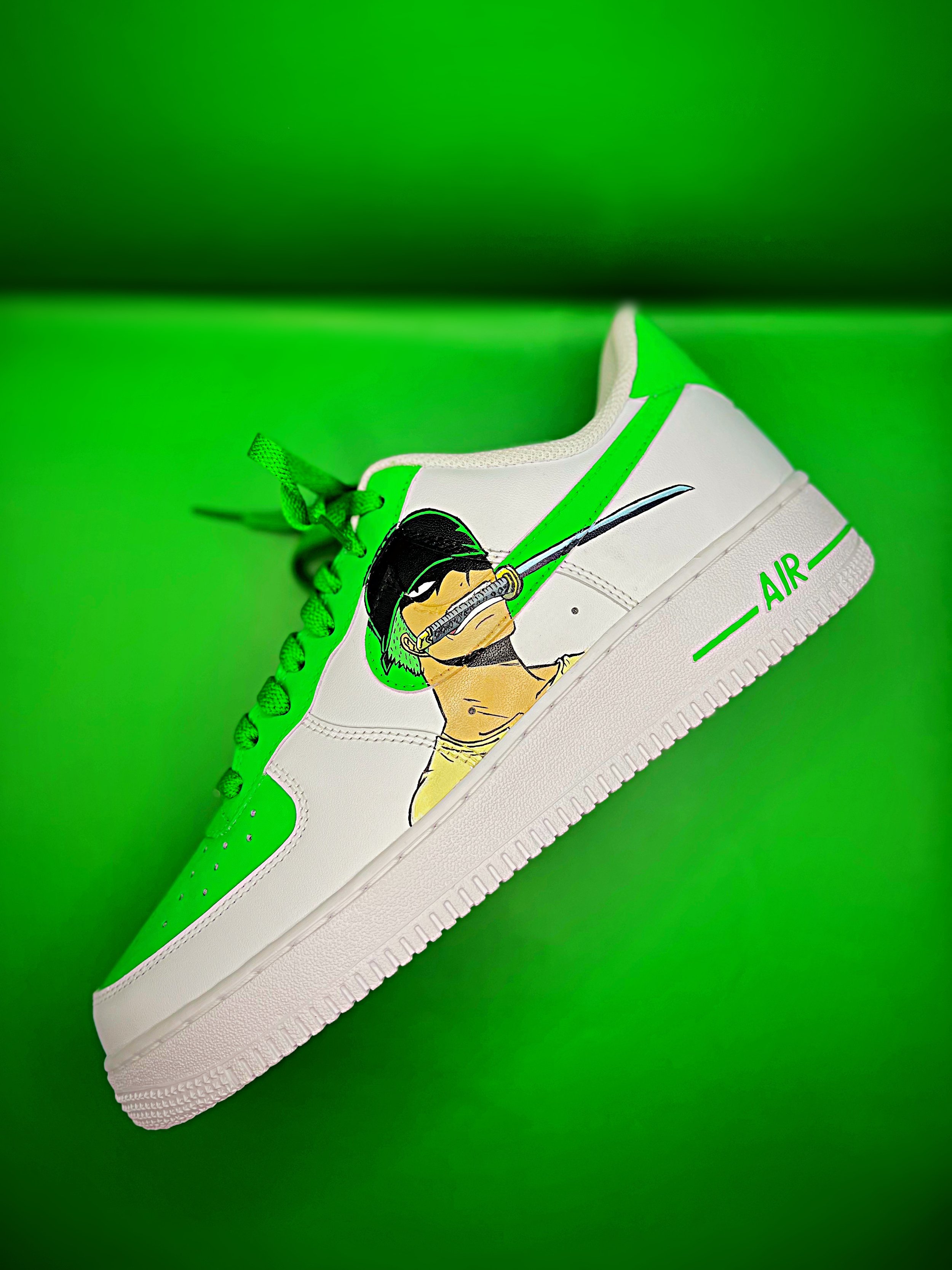 White sneaker with green accents and laces, featuring a graphic of a person with a helmet and goggles, on a green background.
