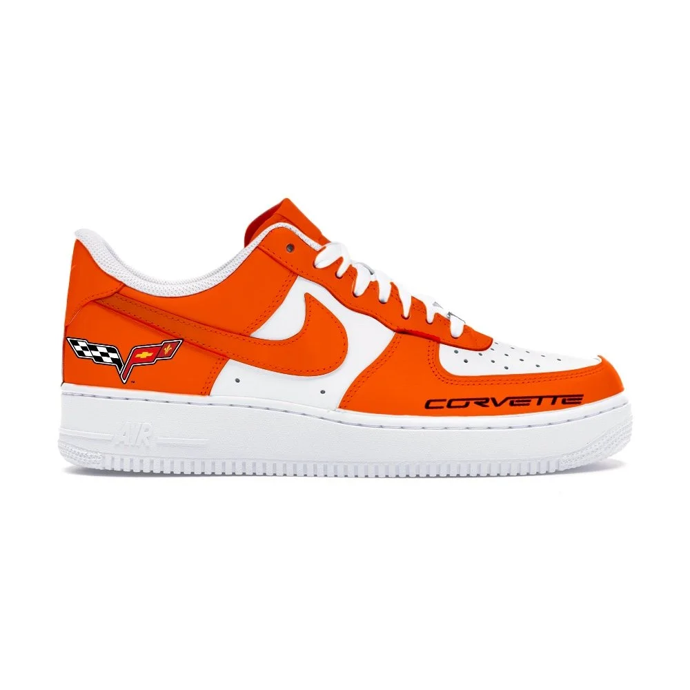 Orange and white Nike sneaker featuring Corvette logo and racing flags design.