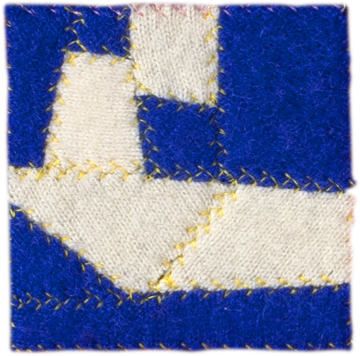 image of geometric textile artwork with multiple colors and patterns including tones of blue and ivory