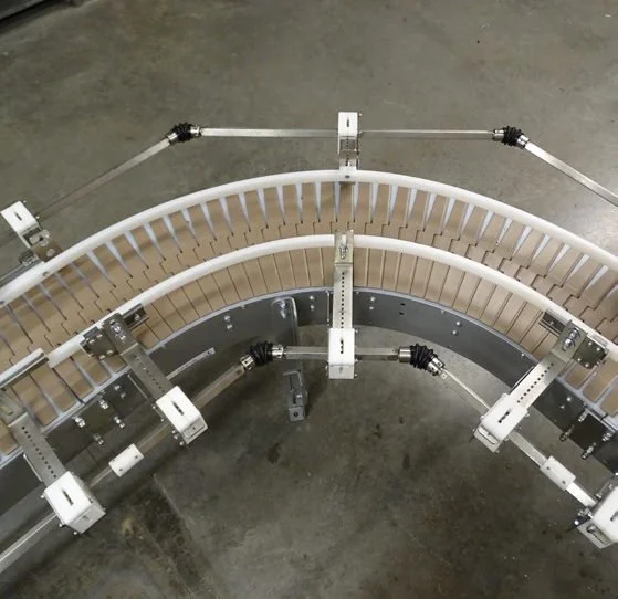 Flighted incline belt conveyor close-up carrying a carton up a steep angle