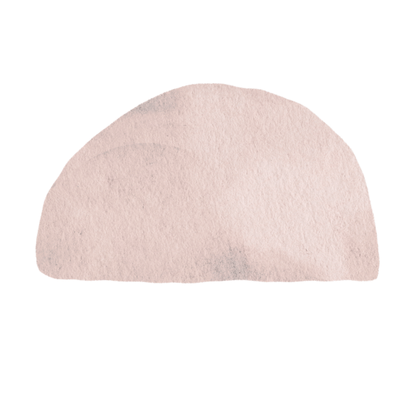 A close-up of a pale pink semi-circular object with a textured surface.
