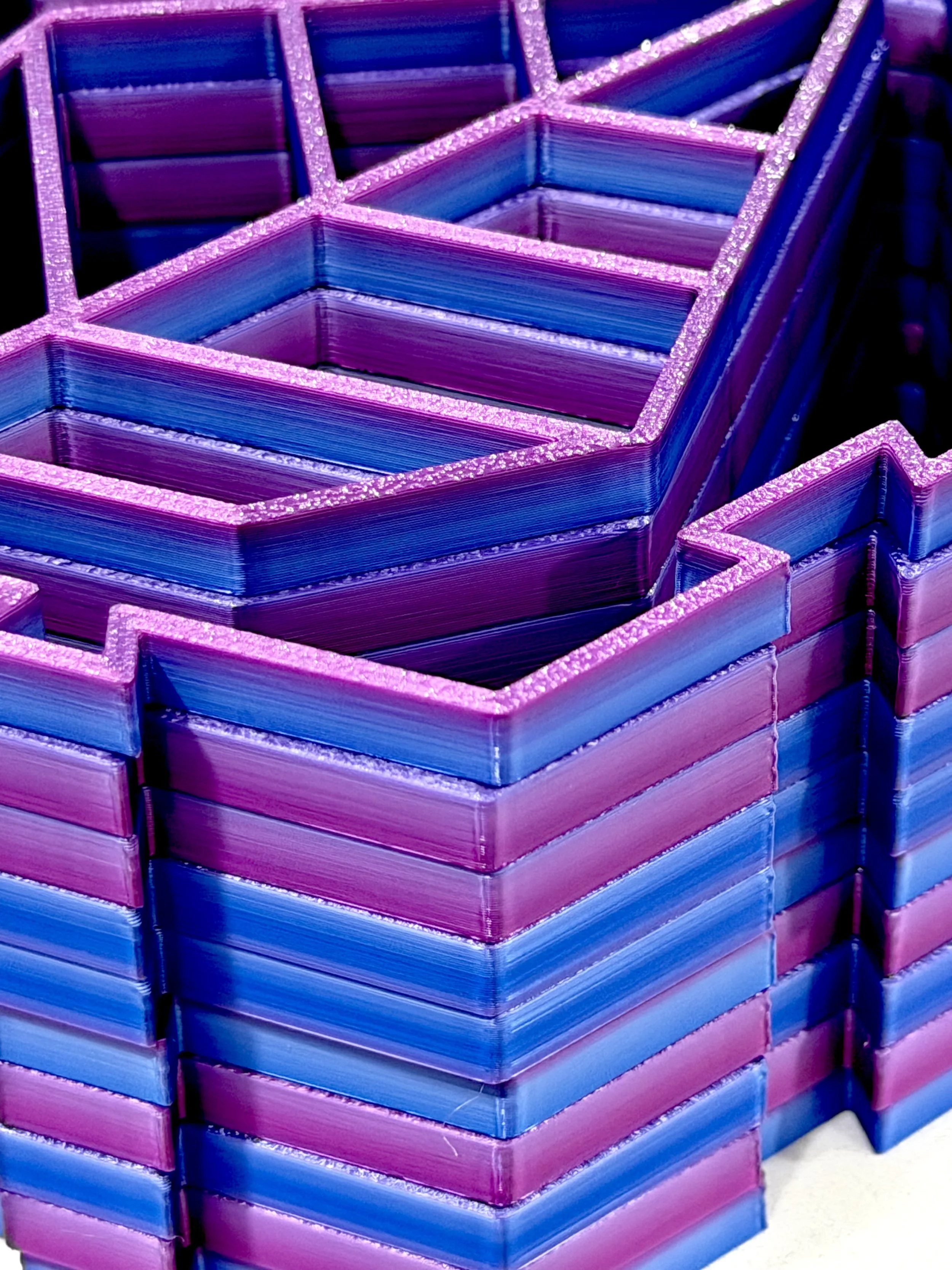 Stacked cubes with neon pink and blue glowing edges.