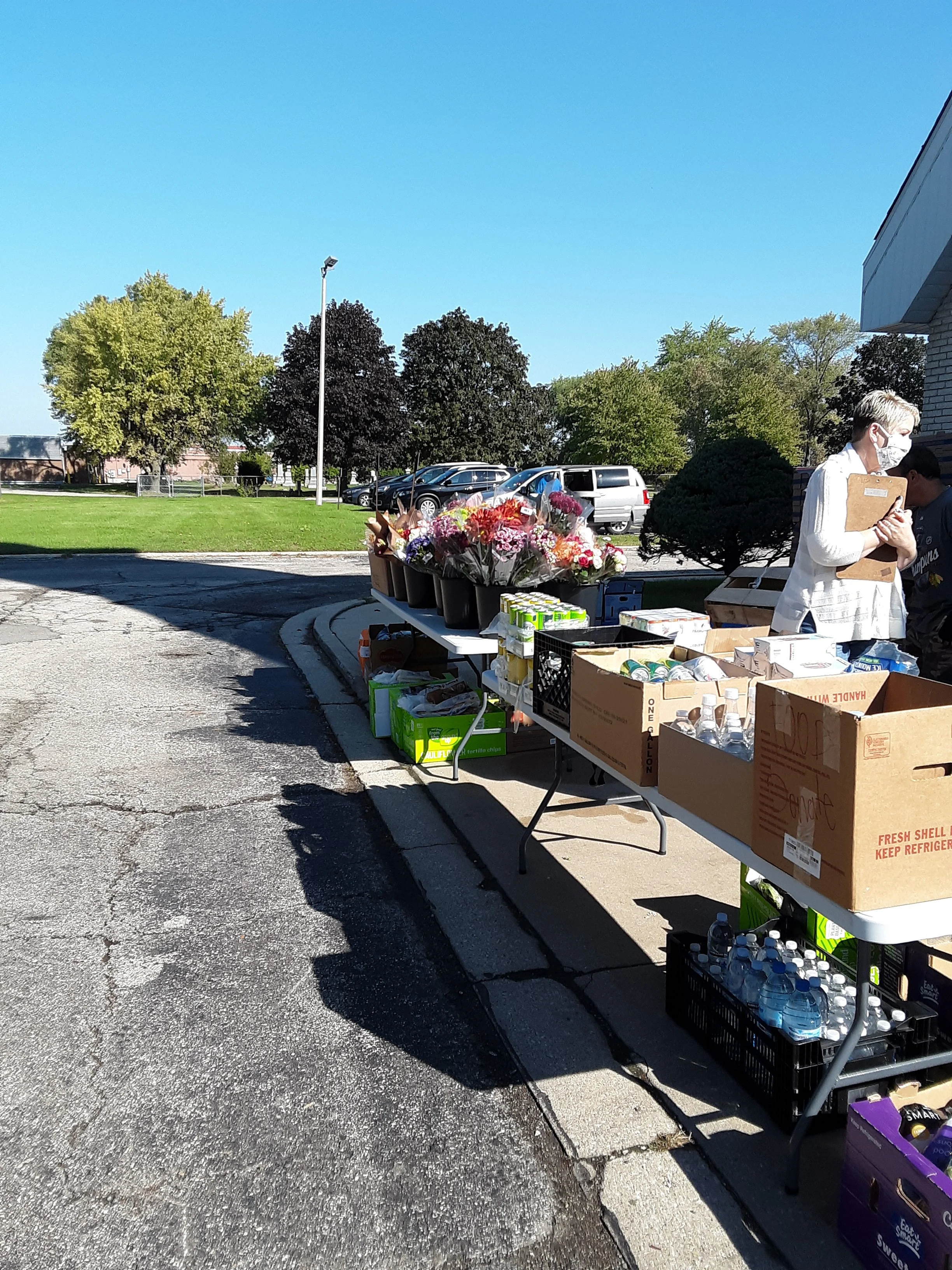 This is a great local church that collects, boxes, and shares food each month. Cars lined up for pick up.