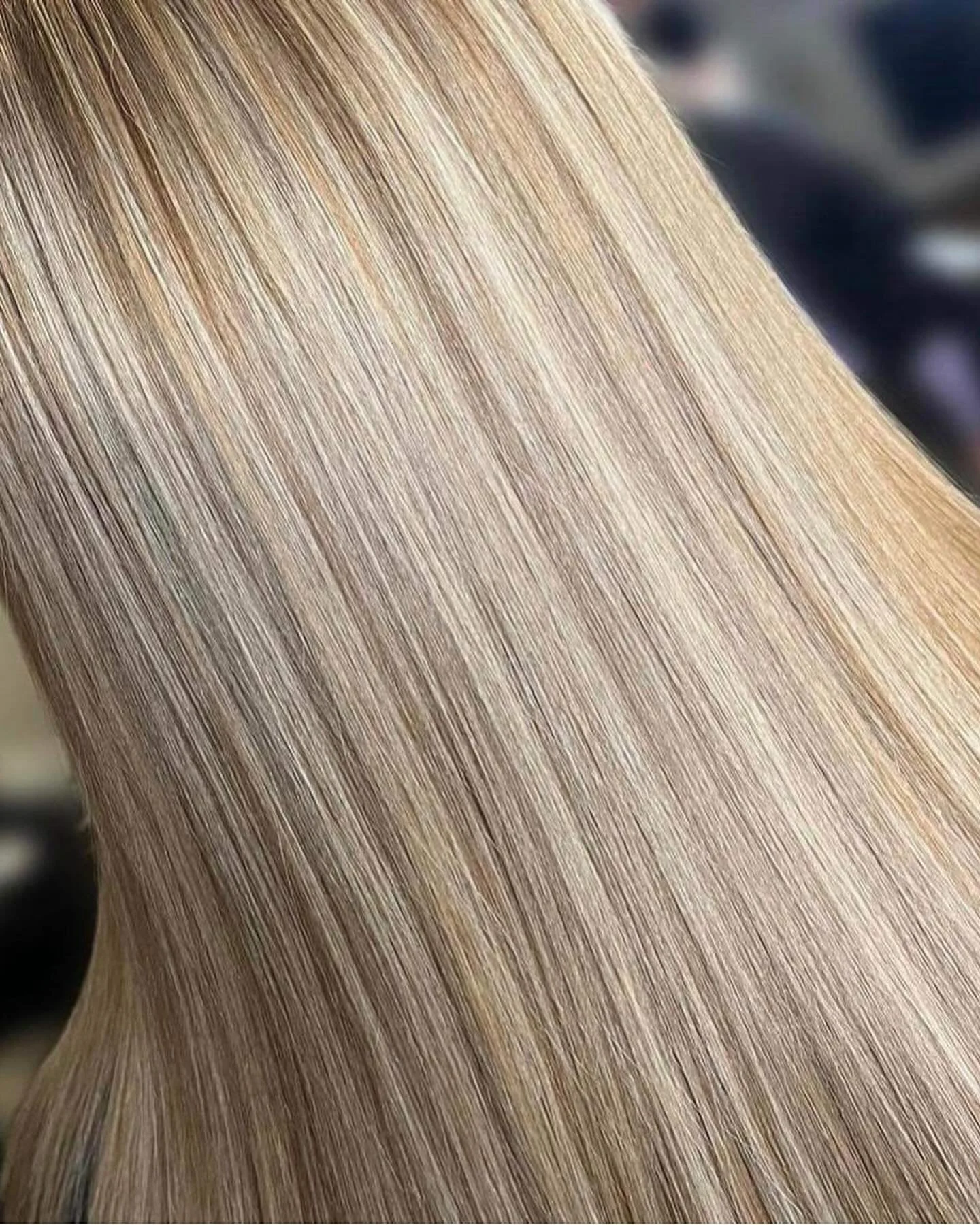Close-up photograph of a person's straight, blonde hair.