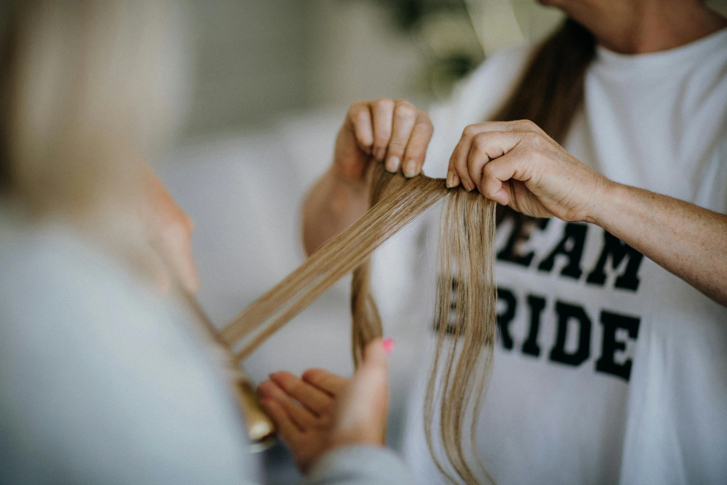 Person holding a wooden frame with long blond hair inside it. Lisa B Hair & Beauty Salon, Carlisle, Cumbria UK.