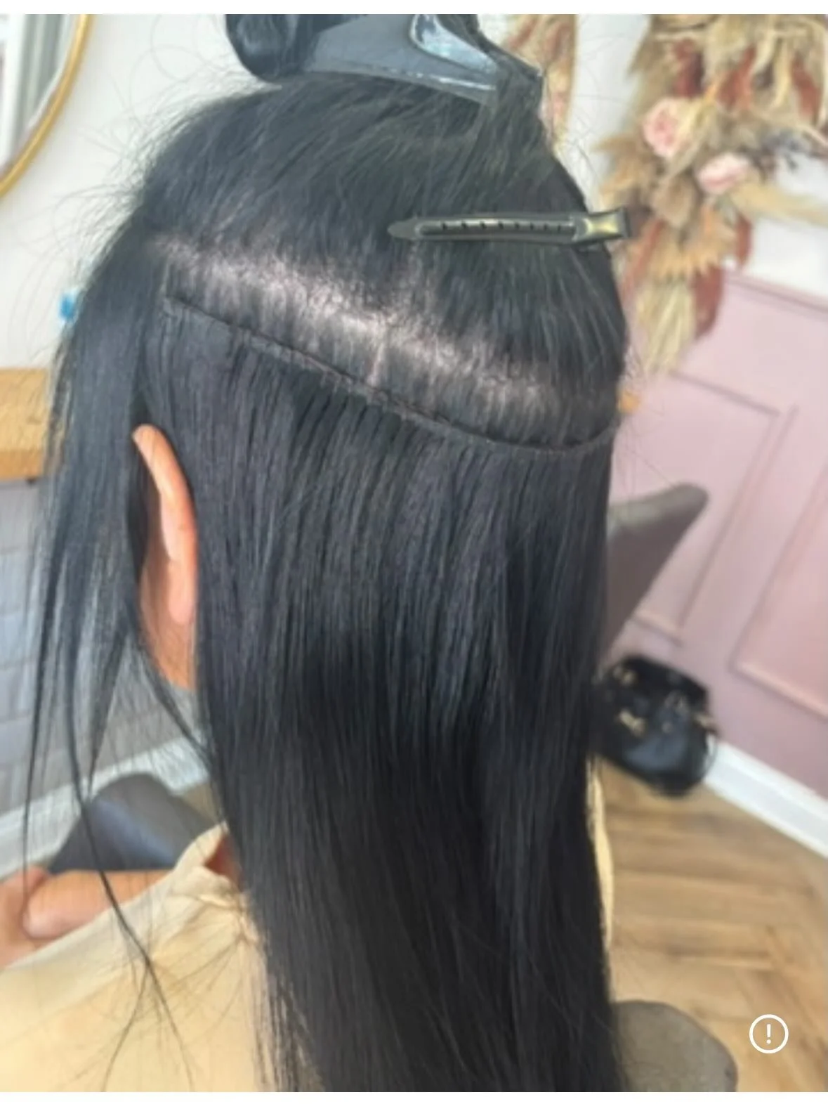 A person with black hair undergoing a hair treatment or styling process, with hair clips and hairpins in place. Lisa B Hair & Beauty Salon, Carlisle, Cumbria UK.
