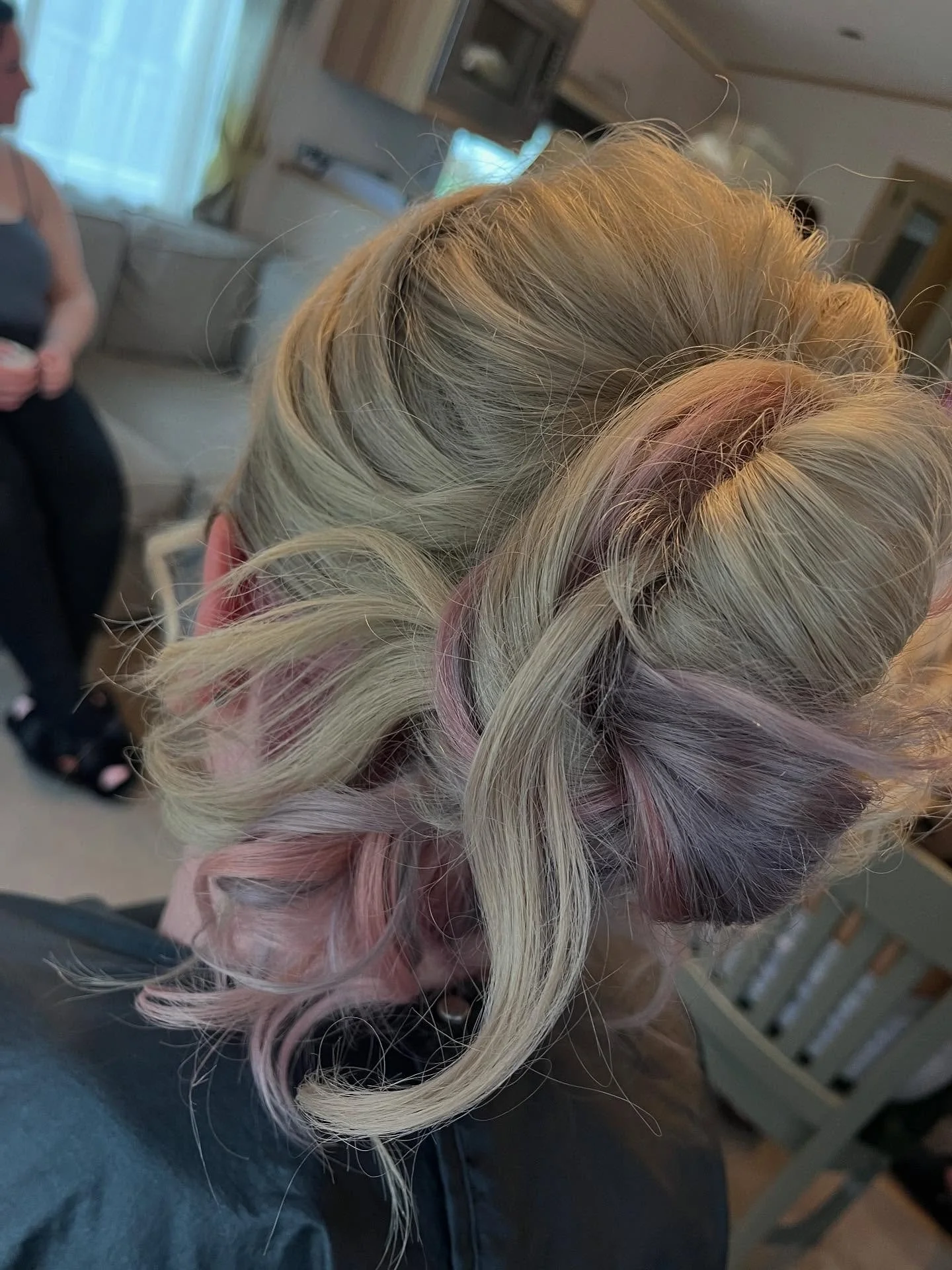 Close-up view of a person's styled hair with platinum blonde and pink highlights, curled into loose waves. Lisa B Hair & Beauty Salon, Carlisle, Cumbria UK.