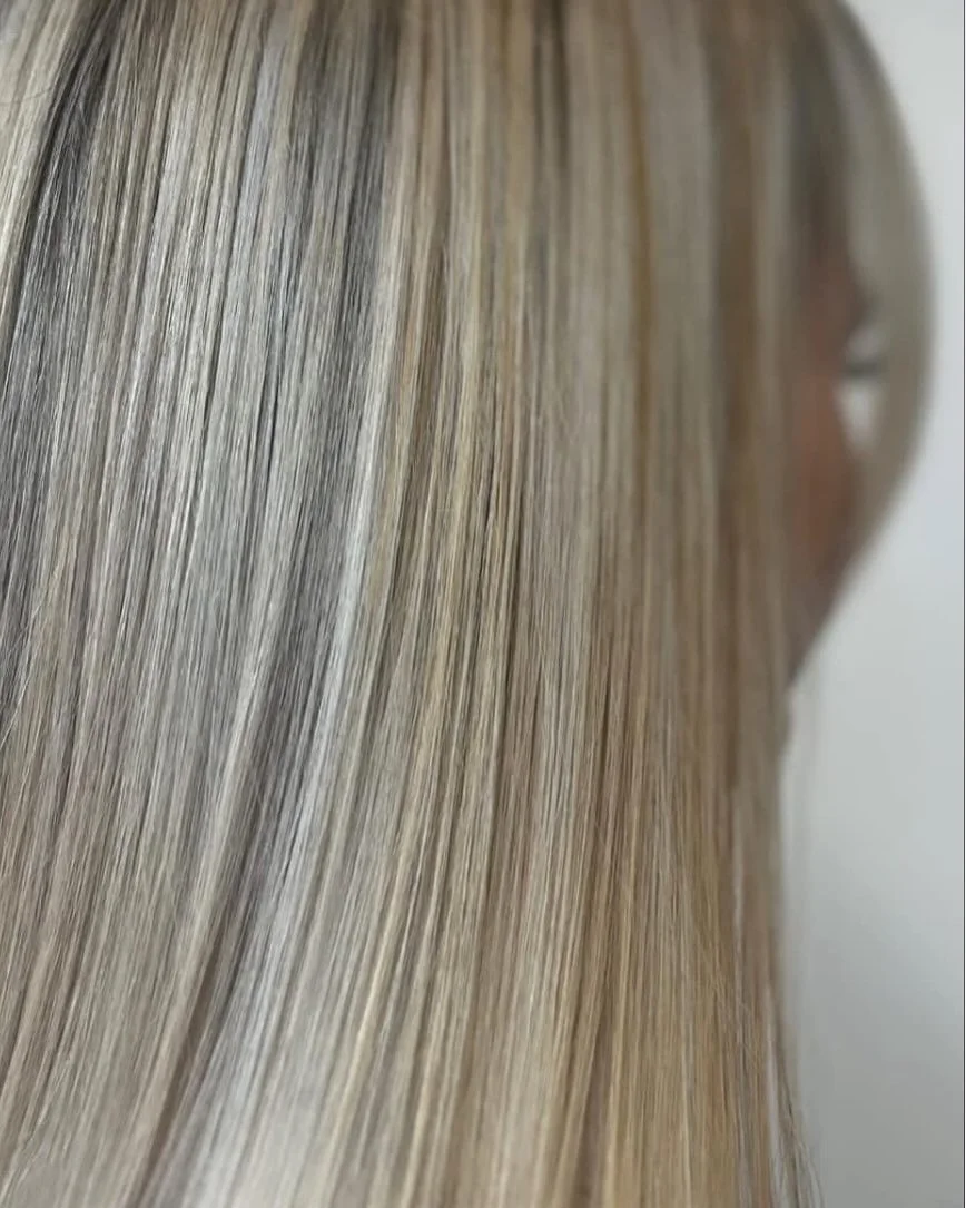 Close-up of a person's long, straight, blonde hair. Lisa B Hair & Beauty Salon, Carlisle, Cumbria UK.