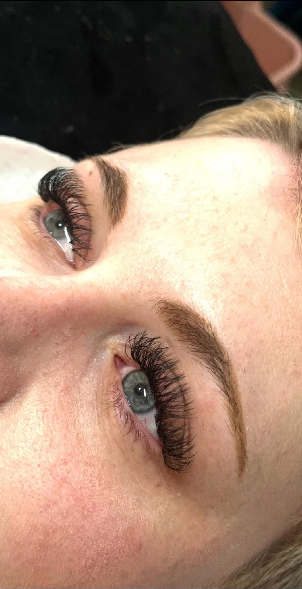 A close-up of a person's face focusing on both eyes, with long lashes and well-groomed eyebrows. Lisa B Hair & Beauty Salon, Carlisle, Cumbria UK.