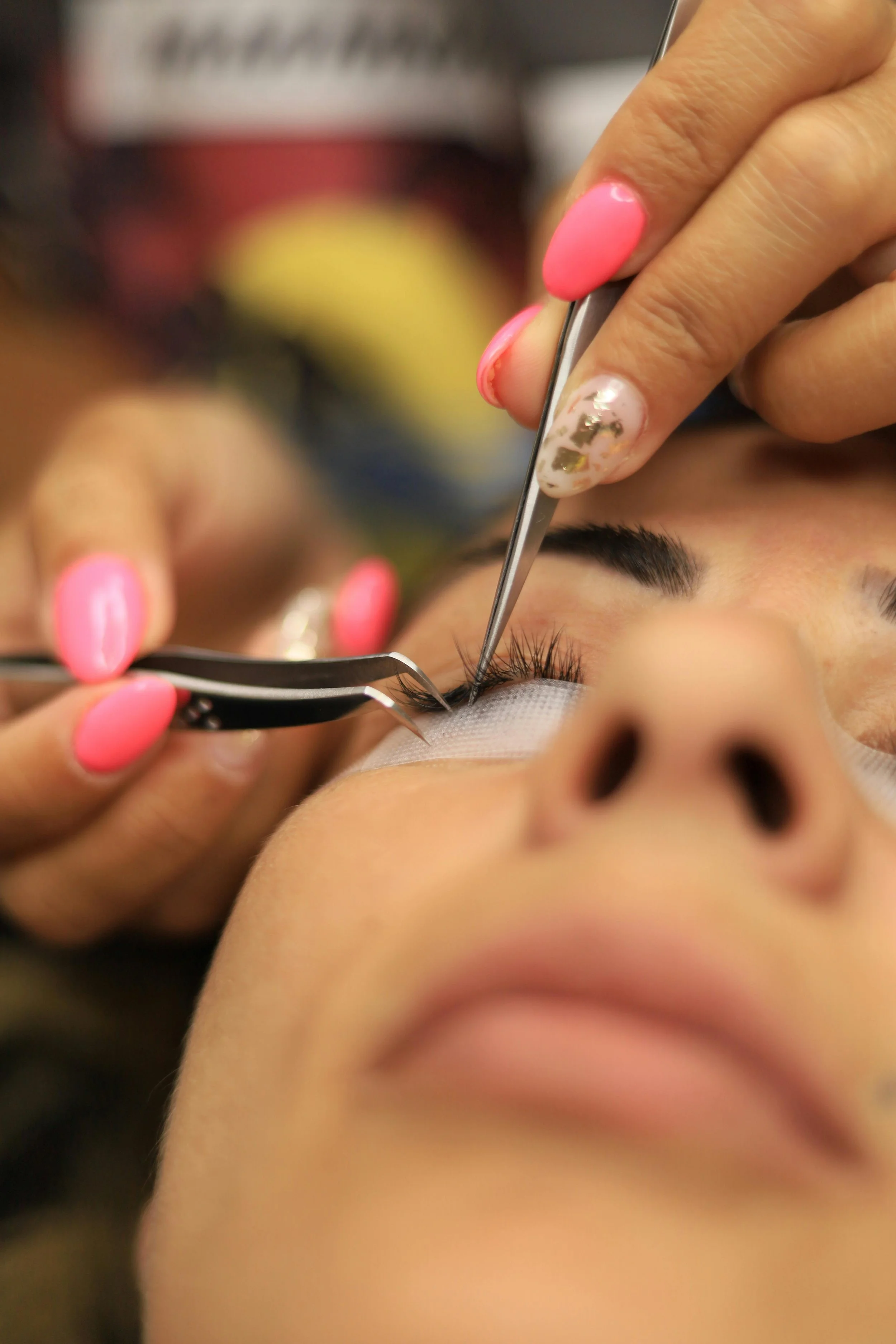 A person receiving eyelash extensions or eyelash grooming, with a close-up view of their eye and hand. Award winning Lisa B Hair and Beauty Salon in Carlisle, Cumbria UK.