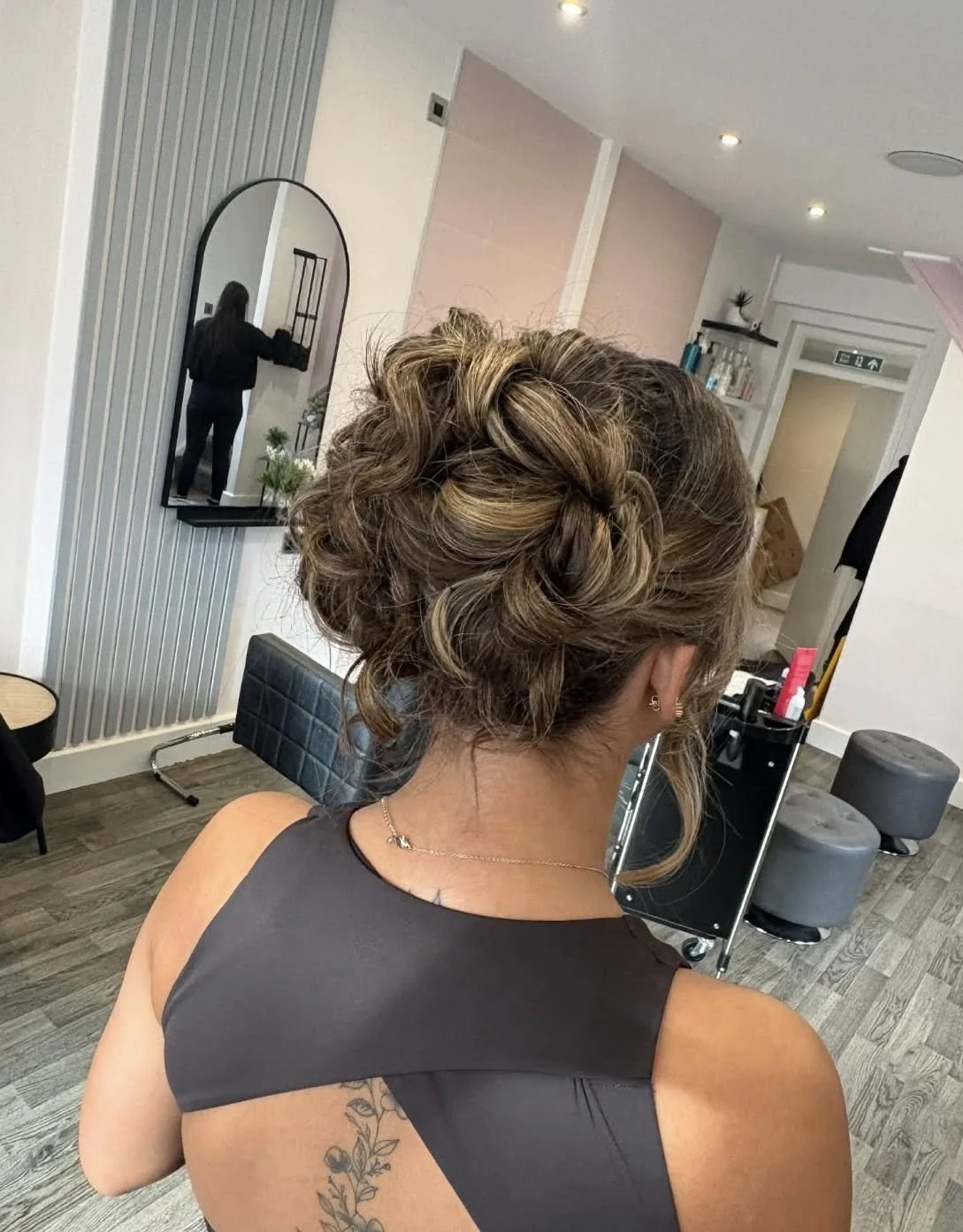 Back of a woman's head with an intricate updo hairstyle, in a salon at Lisa B Hair & Beauty Salon, Carlisle, Cumbria UK.
