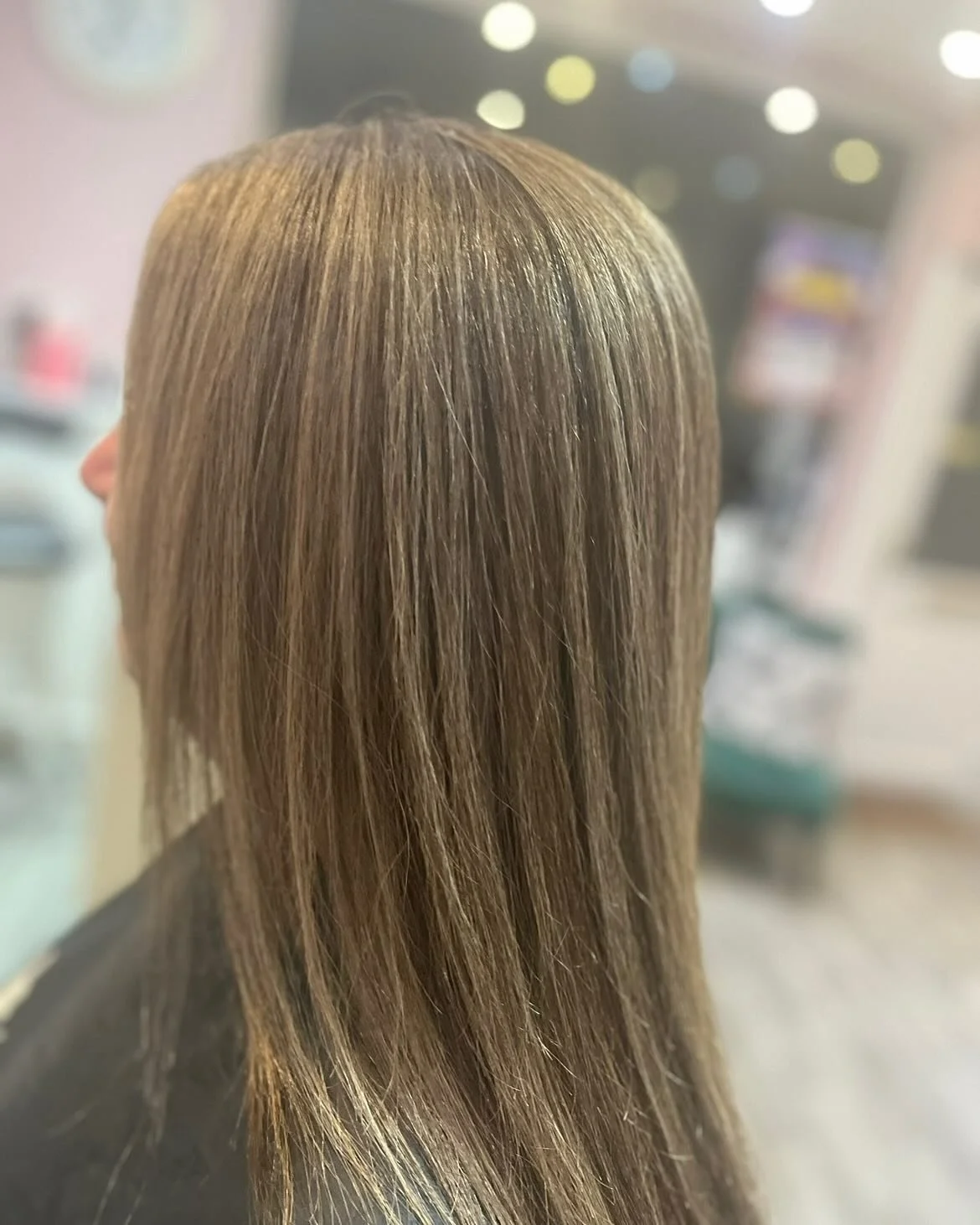 Back view of a woman with straight, shoulder-length, light brown hair. Lisa B Hair & Beauty Salon, Carlisle, Cumbria UK.