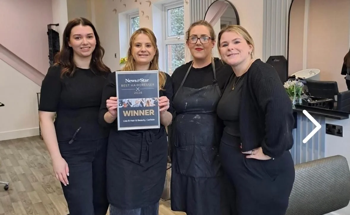 Th team at Lisa B hair and beauty salon, with Lisa holding a framed certificate that reads 'News & Star Best Hairdresser 2026 Winner Lisa B Hair & Beauty, Carlisle'