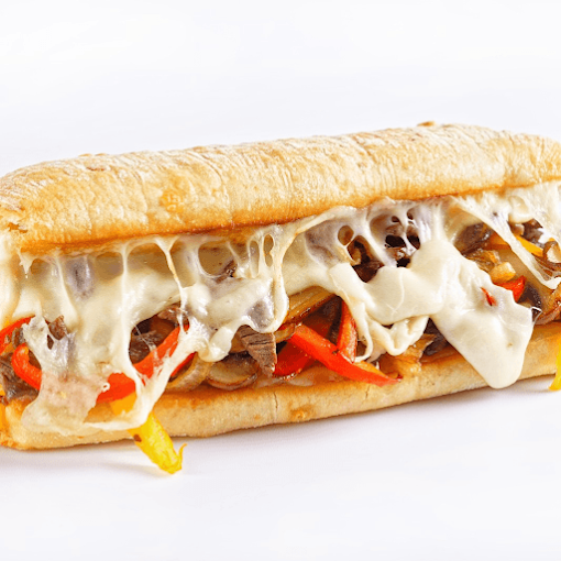 A submarine sandwich with melted cheese, shredded beef, red and yellow bell peppers, and a hoagie roll.