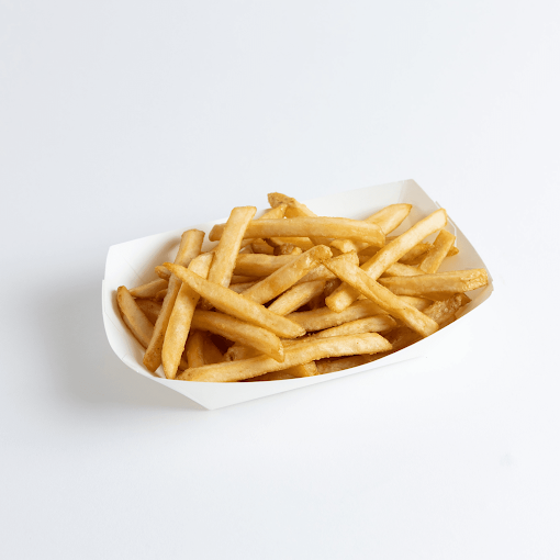 Basket of French fries on a white surface