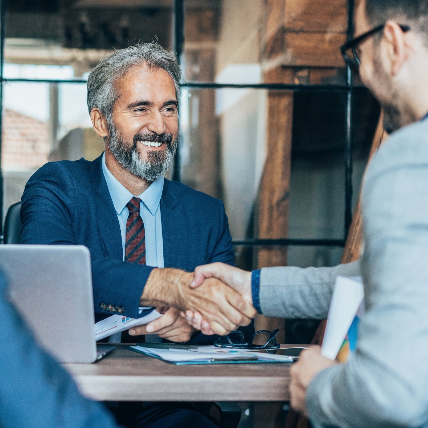 Employer and recruiter shaking hands to begin a hiring partnership