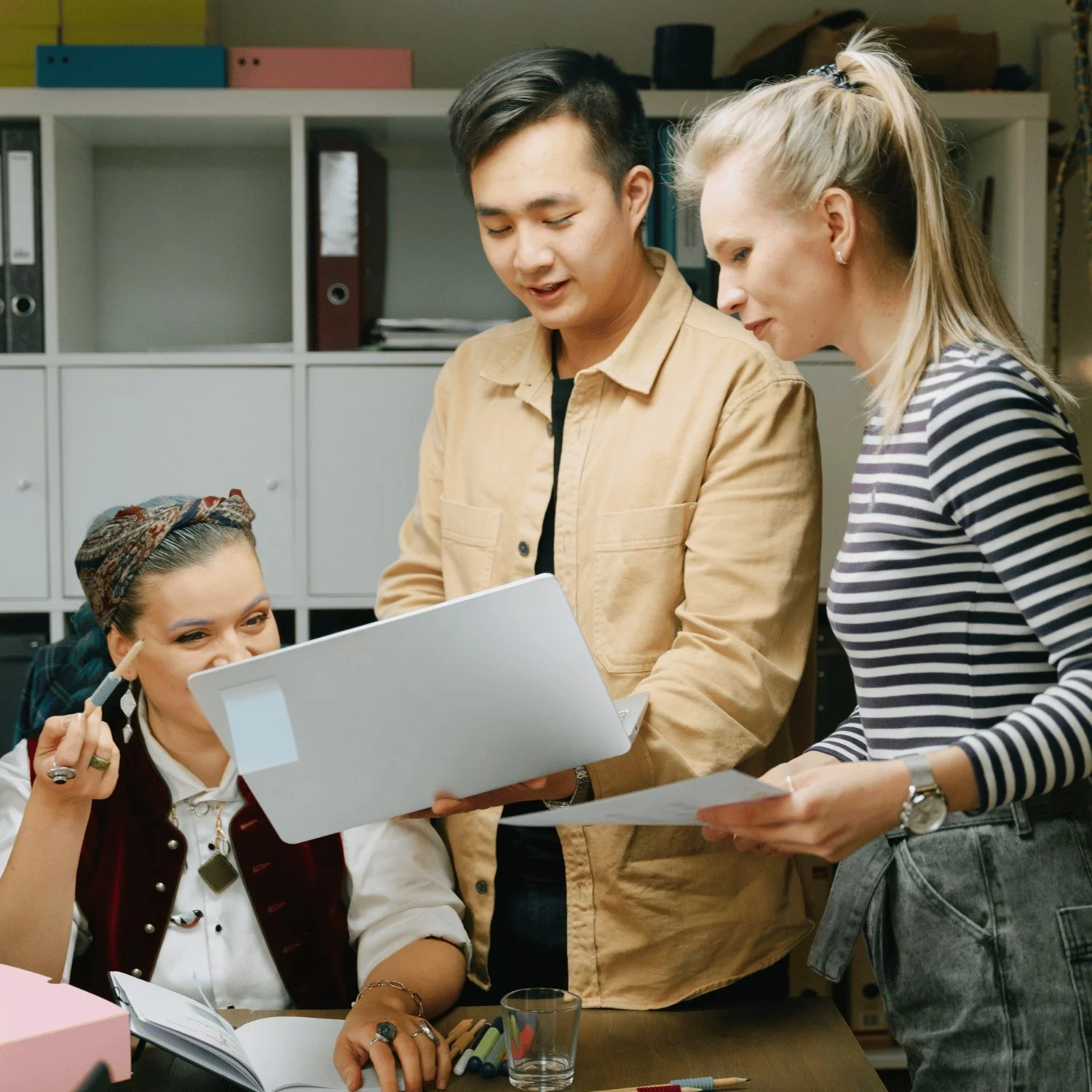Diverse creative team reviewing a candidate's work together in the office