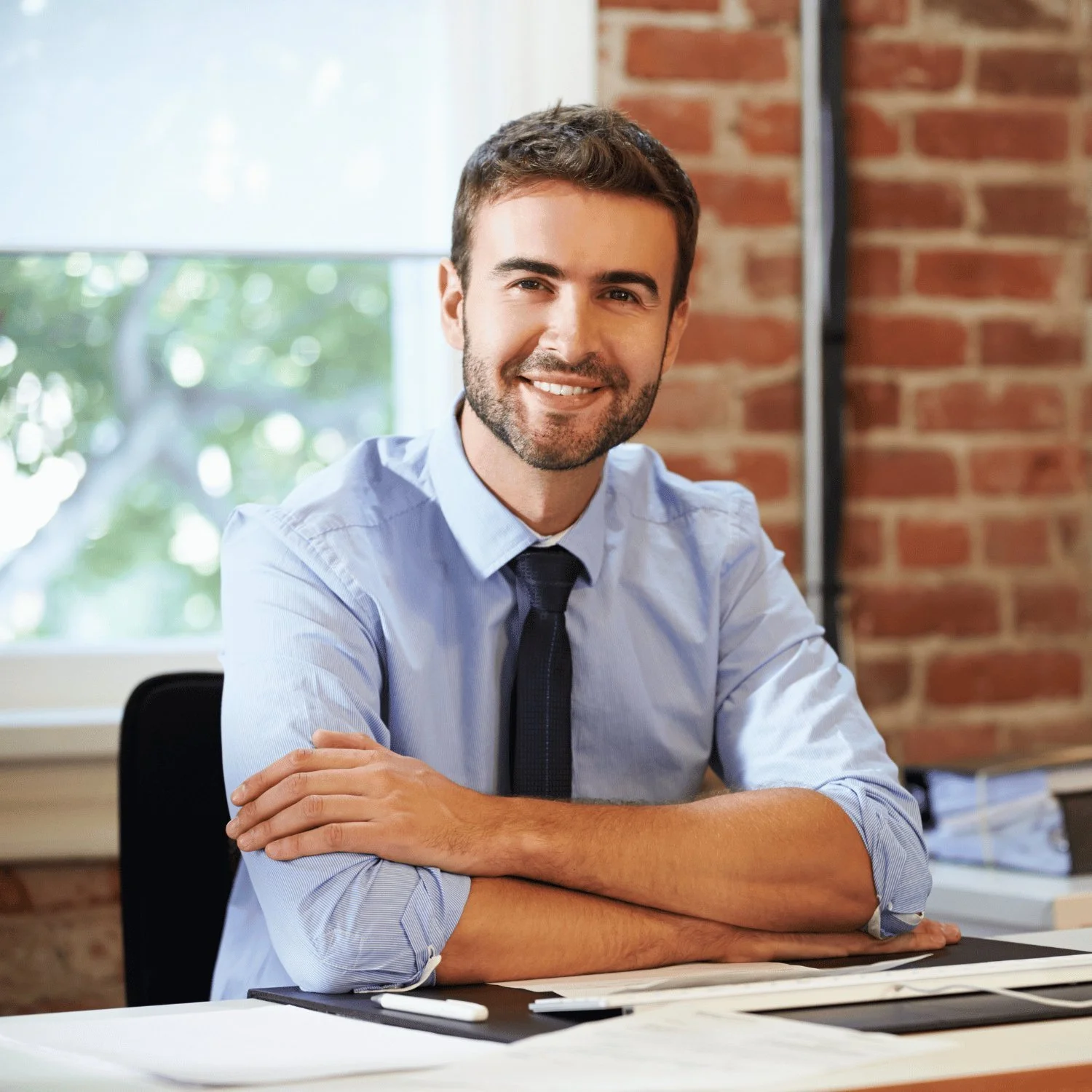 Confident, qualified job candidate at his office desk