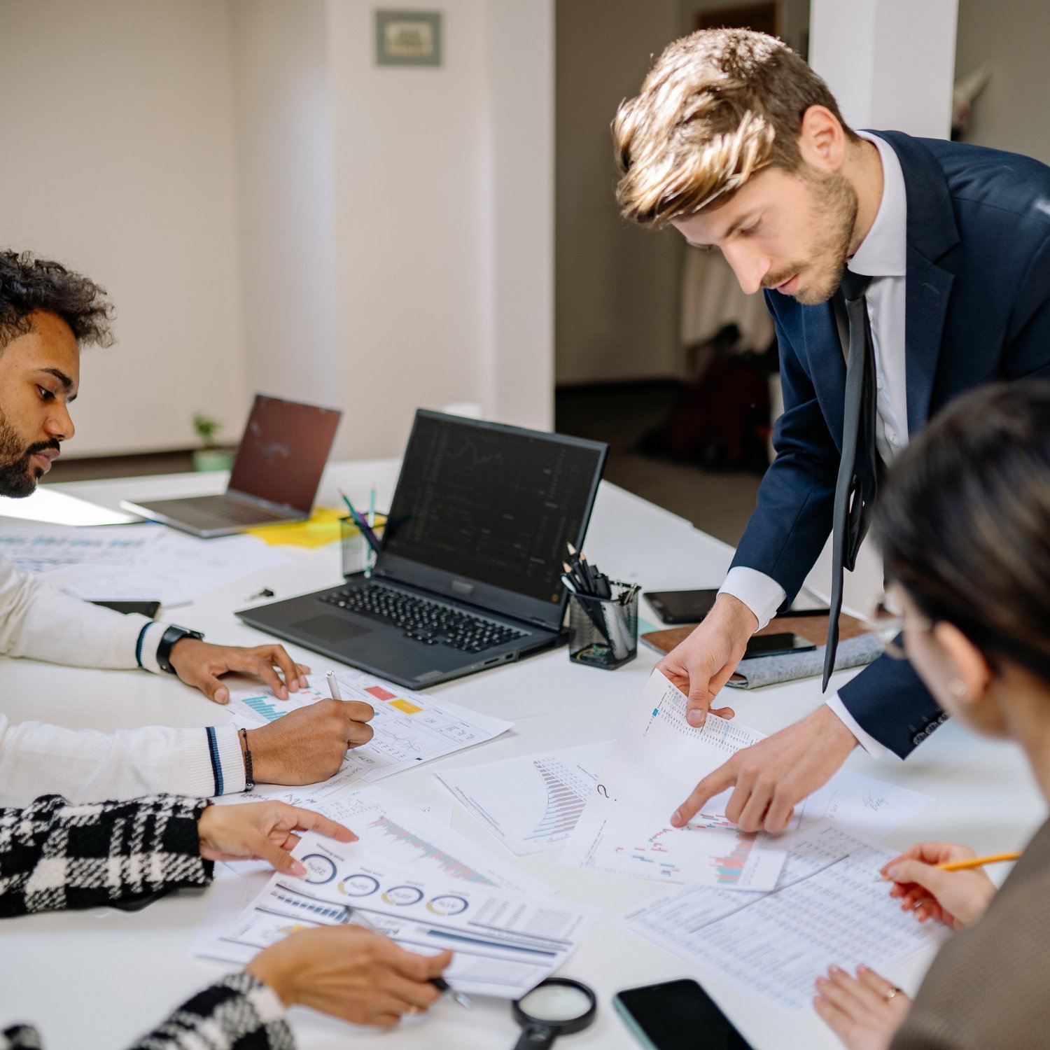 Hiring team analyzing candidate data and reports during a recruitment meeting