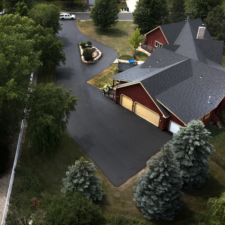 Aerial view of a newly installed residential asphalt driveway by J&W Asphalt