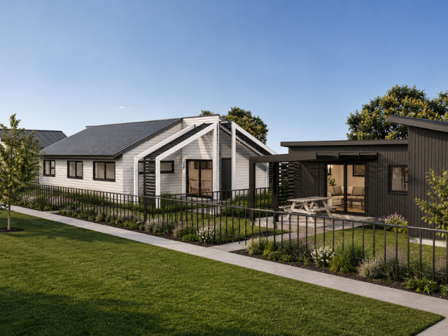 Modern backyard view with two houses, one white and one black, connected by a deck, with a pathway and landscaped garden in front.