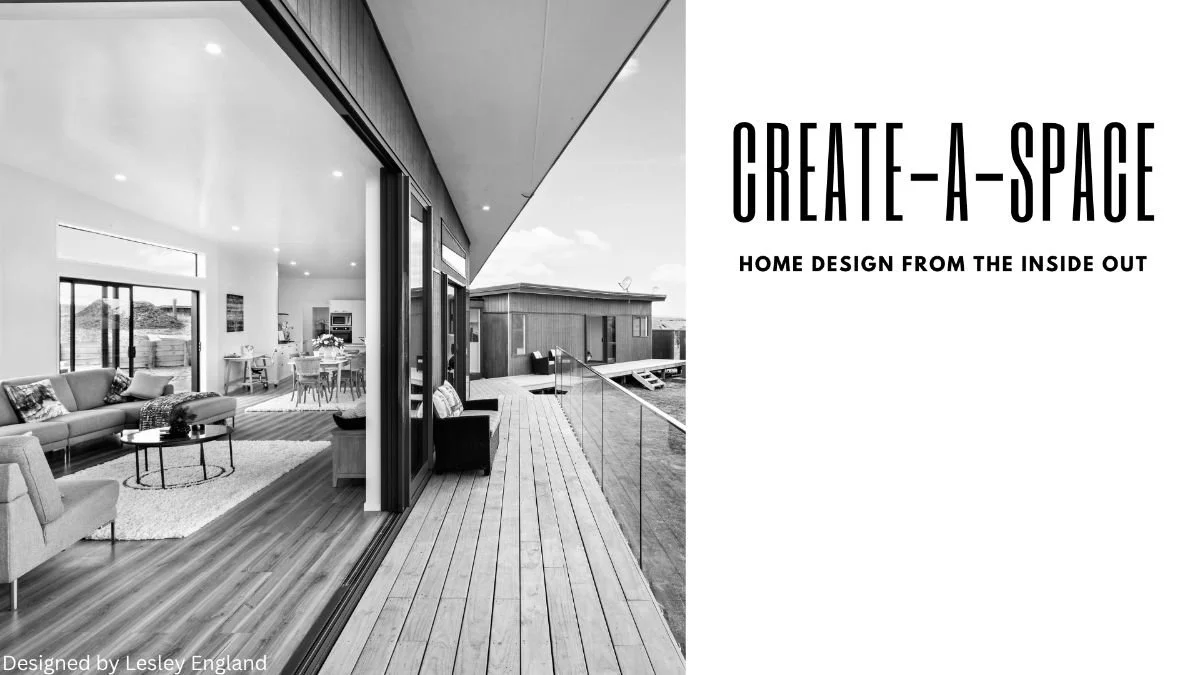 Interior of a modern home with large sliding glass doors opening onto a spacious wooden deck.