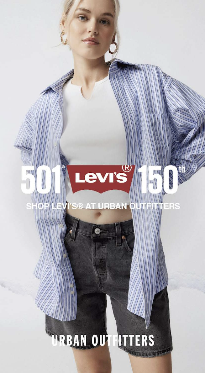 A woman wearing a white t-shirt, a blue striped oversized shirt, and dark gray shorts, posing with a confident expression. Text overlay celebrating Levi's 150th anniversary and promoting shopping at Urban Outfitters.