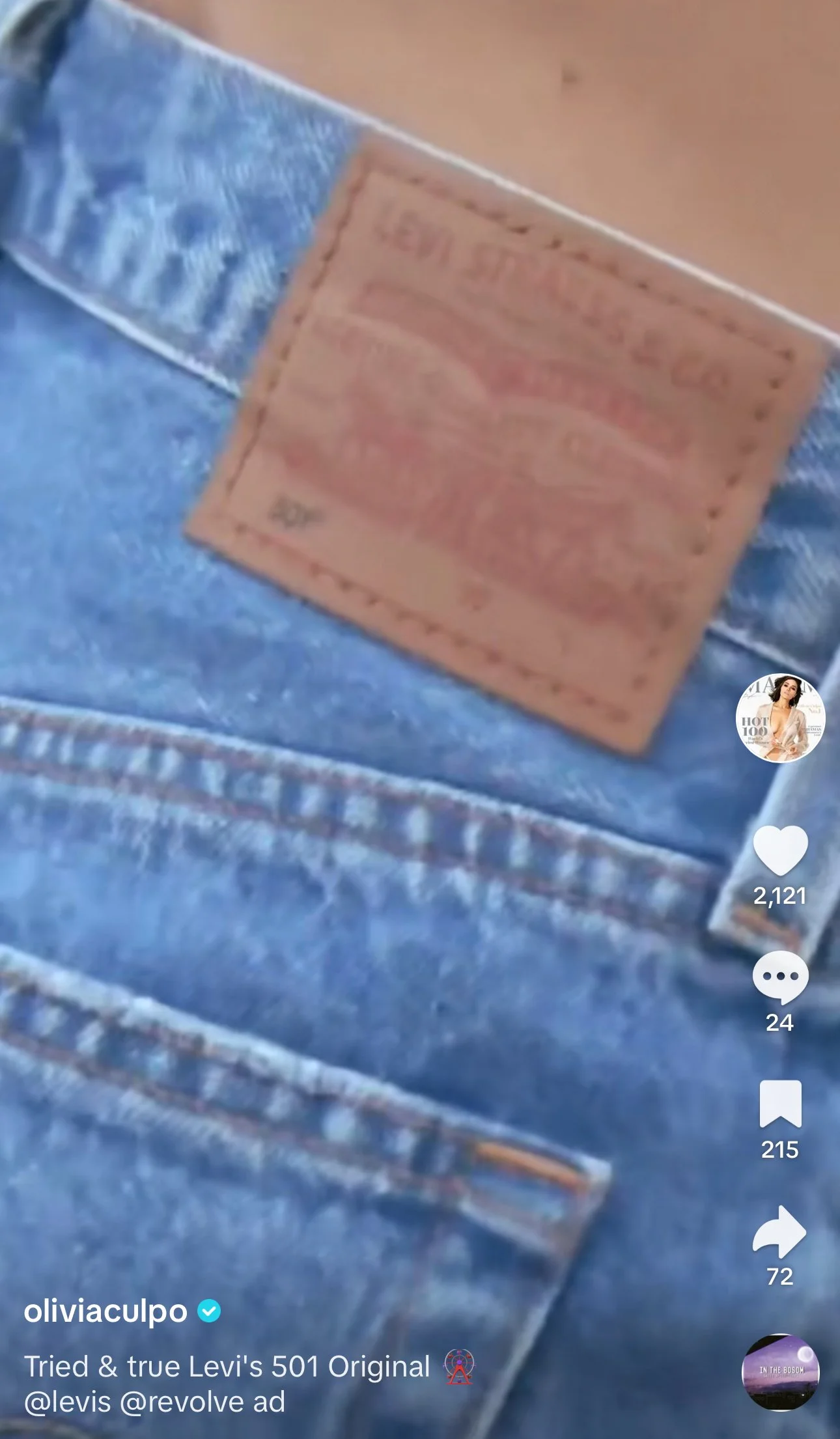 Close-up of Levi's 501 jeans label stitched onto blue denim fabric.