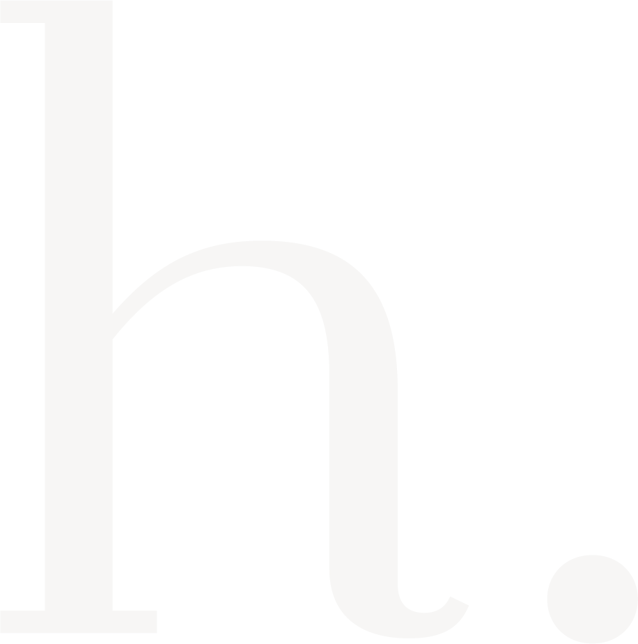 Close-up of a black and white logo on a dark background.