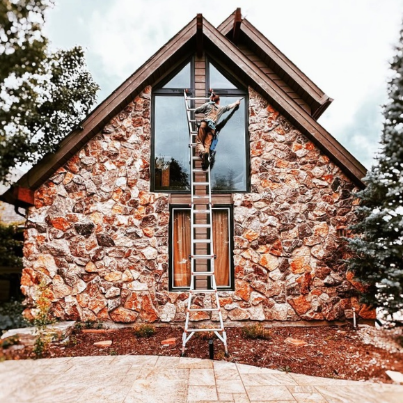 Rise and Shine window cleaner cleaning a picture window in Greeley